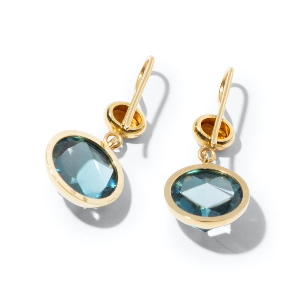 One-of-a-kind and handcrafted pair of 18k gold earrings with crystal clear London Blue Topaz adorned with fiery orange citrines. The typical denim blue color of the gemstone and the minimalist, clean rose cut makes it a modern and versatile piece of