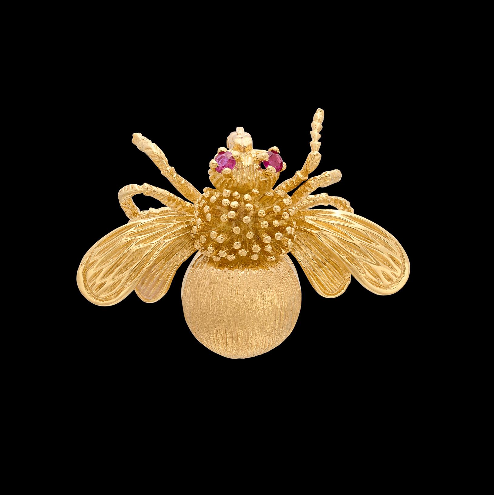 For the entomophile in your life! This gold bug brooch by the one and only Tiffany & Co. circa 1970's features impeccable design and craftsmanship, highlighted by two ruby eyes delivering the perfect pop of color. The piece weighs 12 grams and