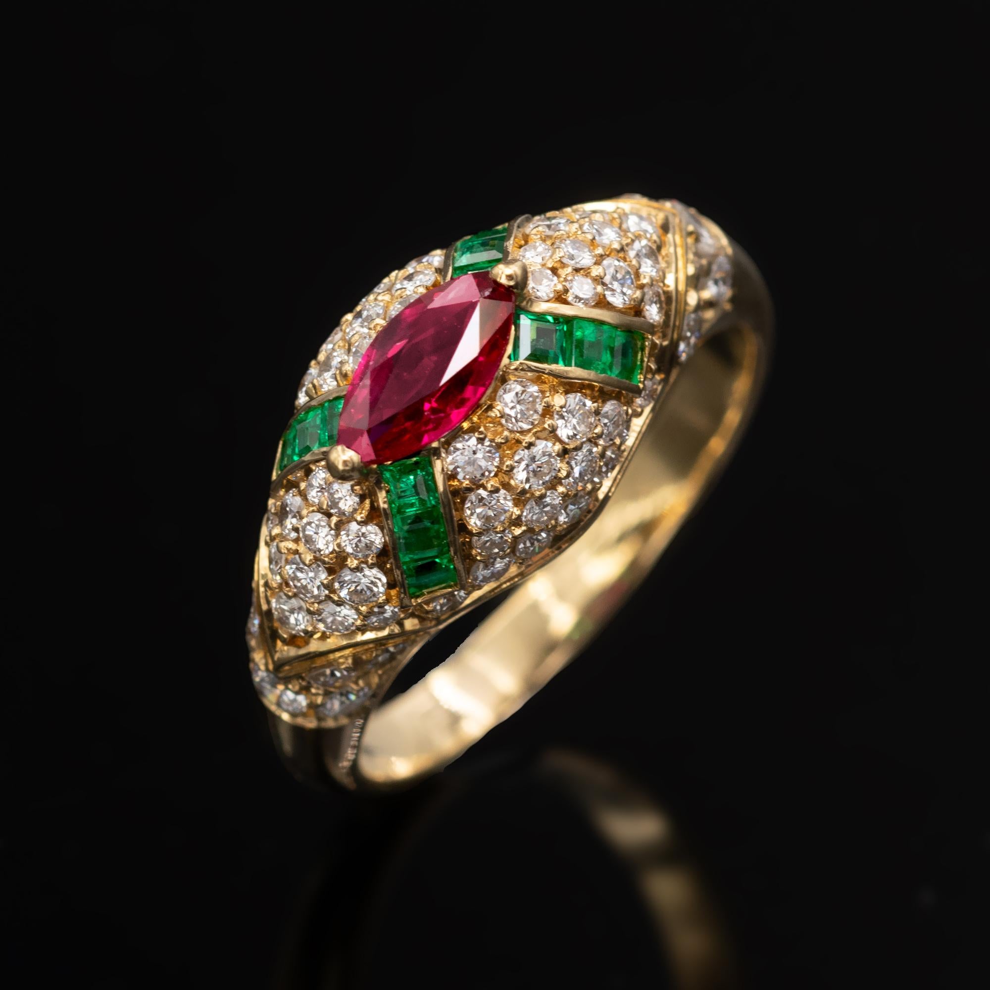 Exquisite ring with an artful design and make. It is a dome ring with a vivid red marquise cut ruby in its center, from which four lines of square emeralds radiate. The whole ring is pavé set with top-quality brilliant cut diamonds. The highly vivid