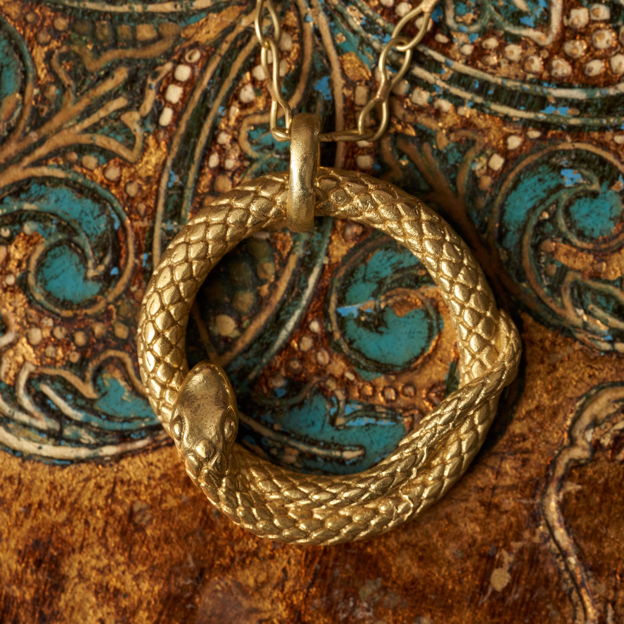 Gently curled, hand crafted snake pendant, in a beautiful weight. Hanging on 20” 18kt gold trace chain.

Pictured on a 20” handmade loose-link chain. Different chain options available, please contact us for pricing options.

Symbolism:
The snake has