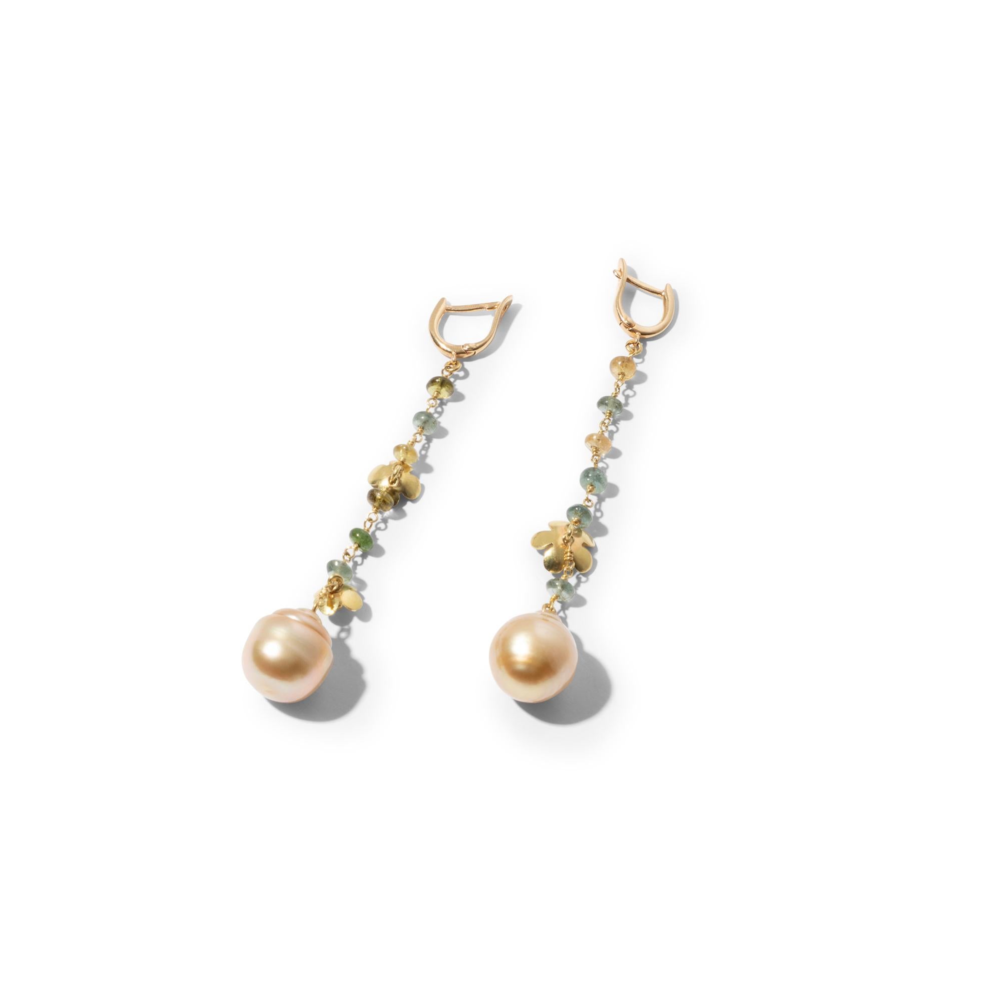 Very delicate and feminine one-of-a-kind pair of earrings with golden yellow South Sea pearls and dainty little golden flowers. This asymmetrical pair features two baroque South Sea pearls of exceptional beauty with great golden lustre. It strikes