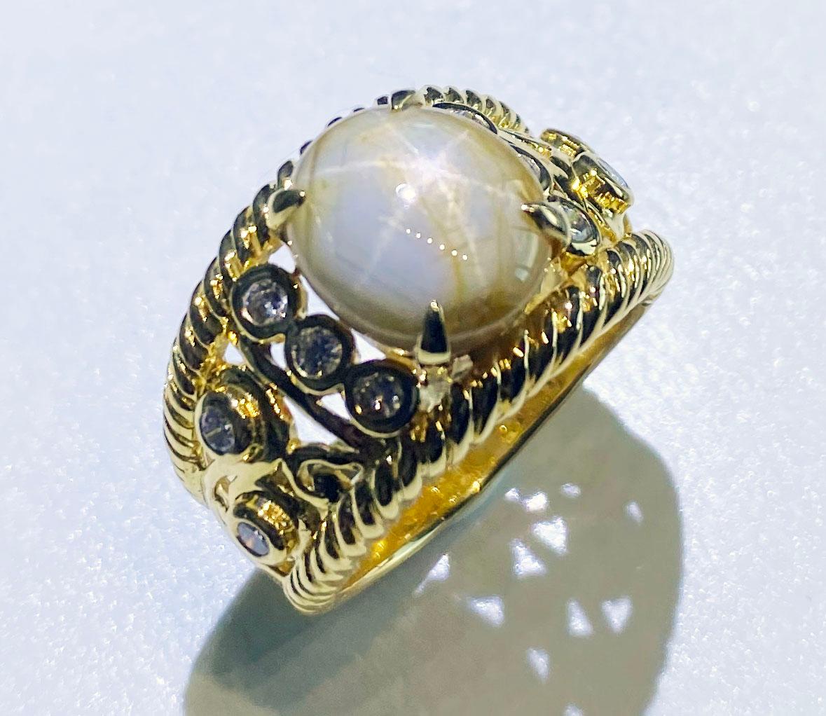 A Star Sapphire & Diamond Ring set in 18kt Yellow Gold set with a Milk & Honey Star Sapphire surrounded by Diamonds. This Star Sapphire is a hefty 12.41 Carats originating from Sri Lanka. The Ring  size is a USA 11. The Sapphire is accented by 10