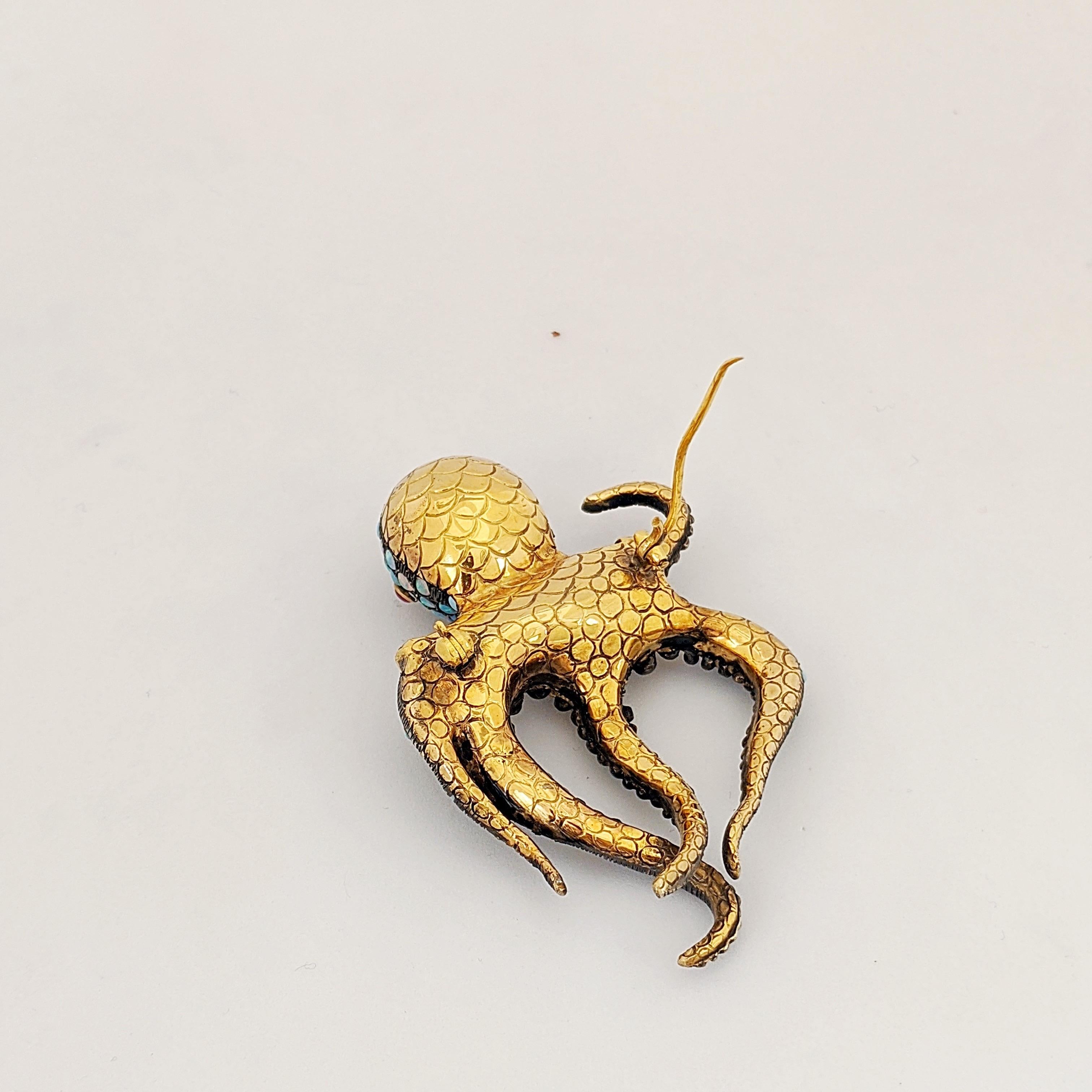 A whimsical Octopus brooch .
This beautiful brooch is crafted by Irlan in a combination of 18 karat yellow gold and sterling silver. The entire front of the  Octopus is set with round opals. He has a sash of Diamonds and Ruby eyes.  He measures 2.5