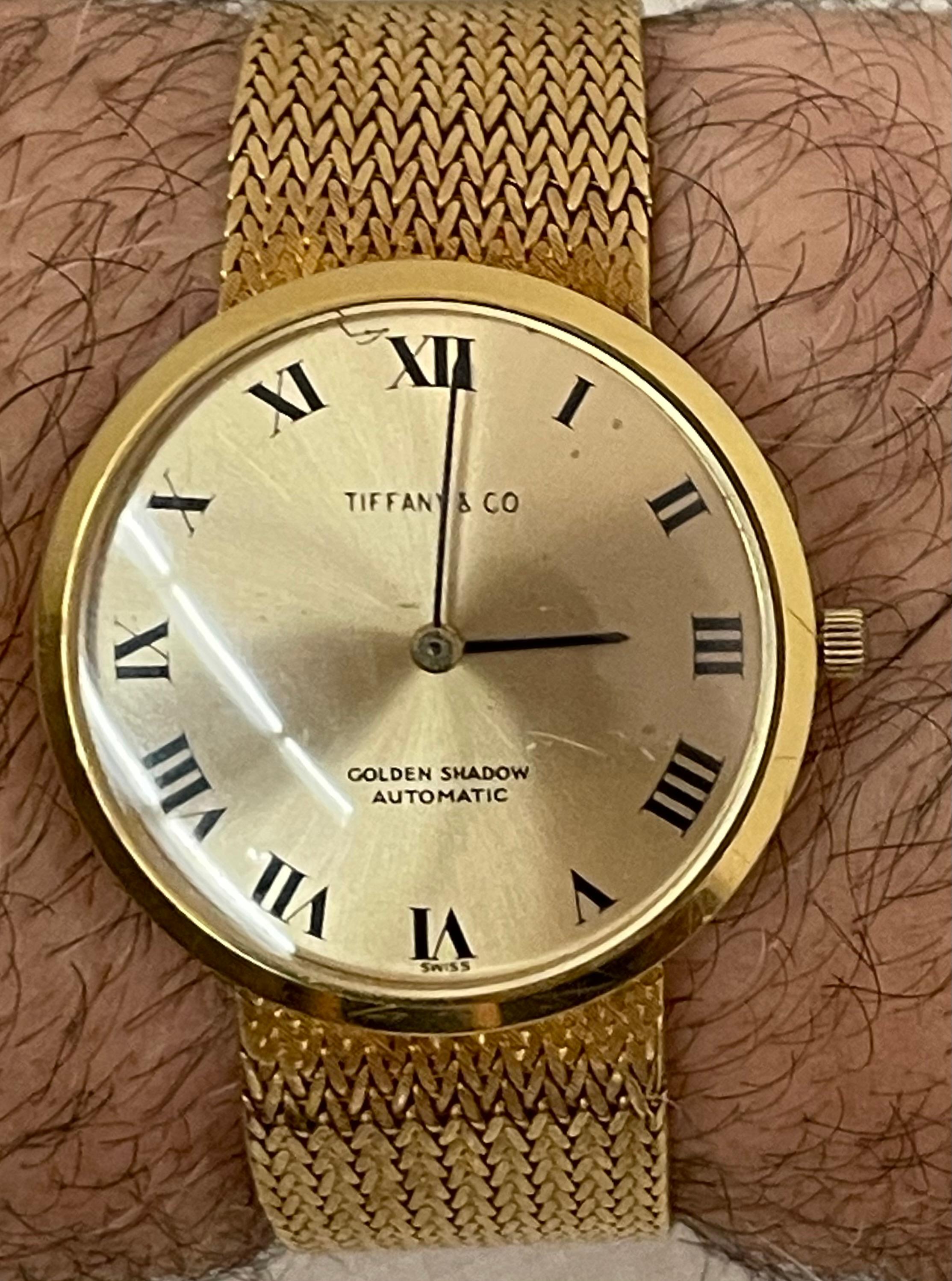 18KT Yellow Gold Tiffany and Co Golden Shadow Wrist Watch, 1965

Tiffany 18Kt weighing 66.3 grams total. Bracelet size 6.75 inches. 

The Golden Shadow had three lines - the White Shadow cased in stainless steel, the Gilt Shadow, cased in gold