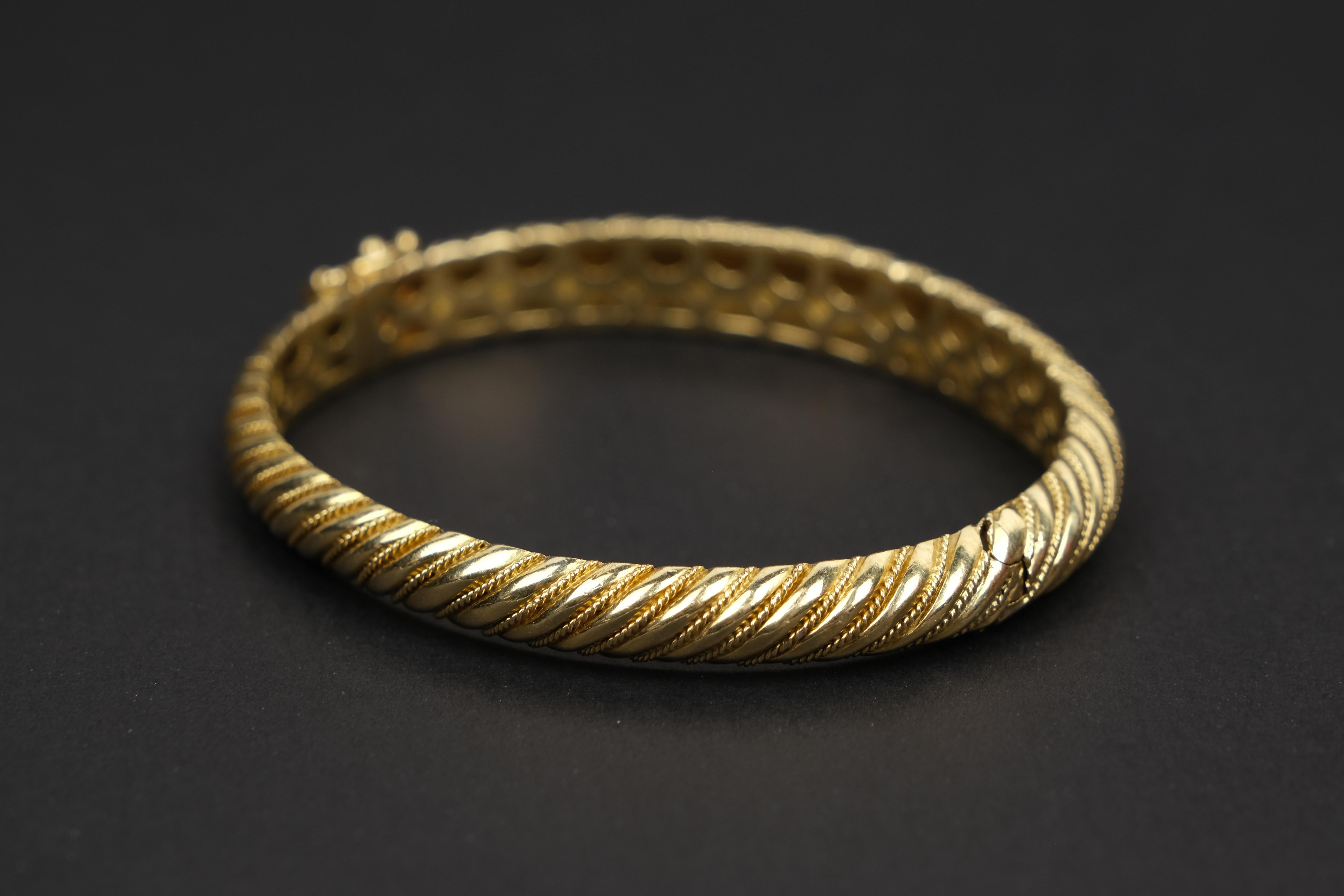 18 Karat Gold Torsade Bracelet- 30.5 grams of elegant 18kt.

Inner circumference: 6.5 Inches / 16.5 cm
Outer circumference: 8 inches / 20 cm
Diameter: 2.2 inches / 5.6 cm

I saw this at an estate auction and to be truthful the immediate attraction