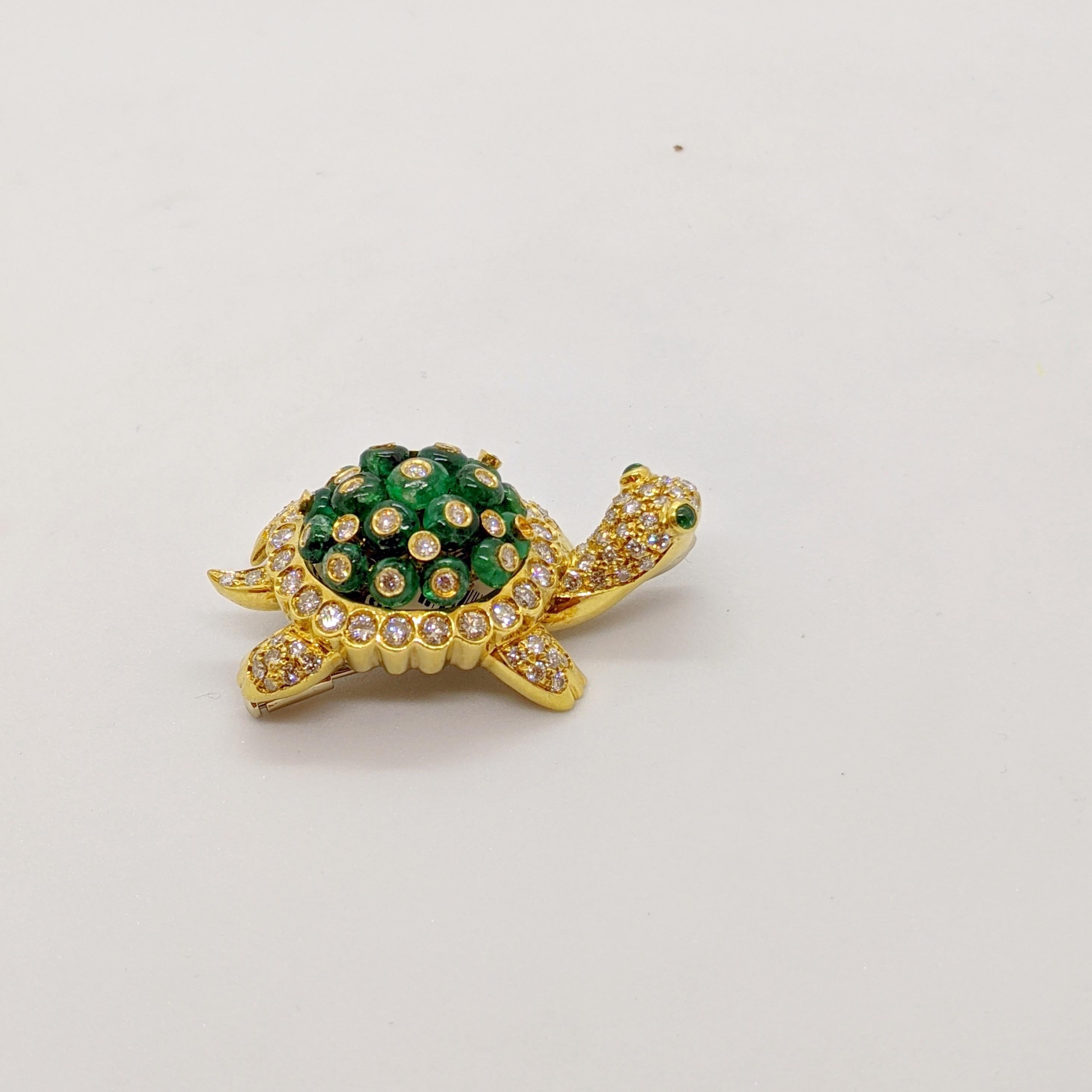 Elegant and Adorable is the best way to describe this lovely 18 karat yellow gold Turtle brooch. His entire shell is set with beaded Emeralds that have been  finished with round bezel set Brilliant Diamonds. The balance of his body , all set with