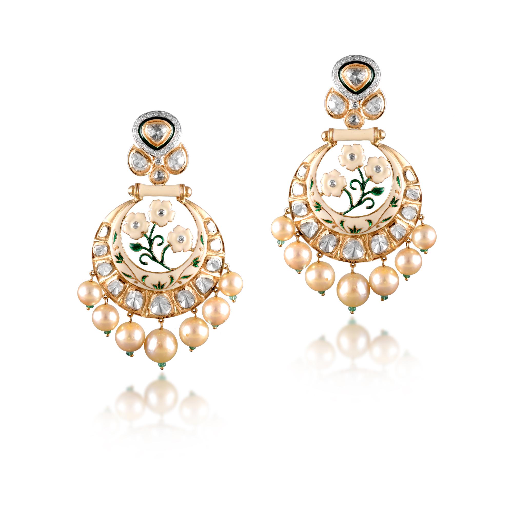 Diamond: 1.00 carat 
Polki: 4.38 carat
Pearl: 84.43 carat
Emerald: 0.76 carat
18kt Gold: 32.426 grams 
Ref No: DT-GED
Stunning earrings inspired by the white lotus, envisages an aura of tranquility and elegance. The floral motifs and the south sea