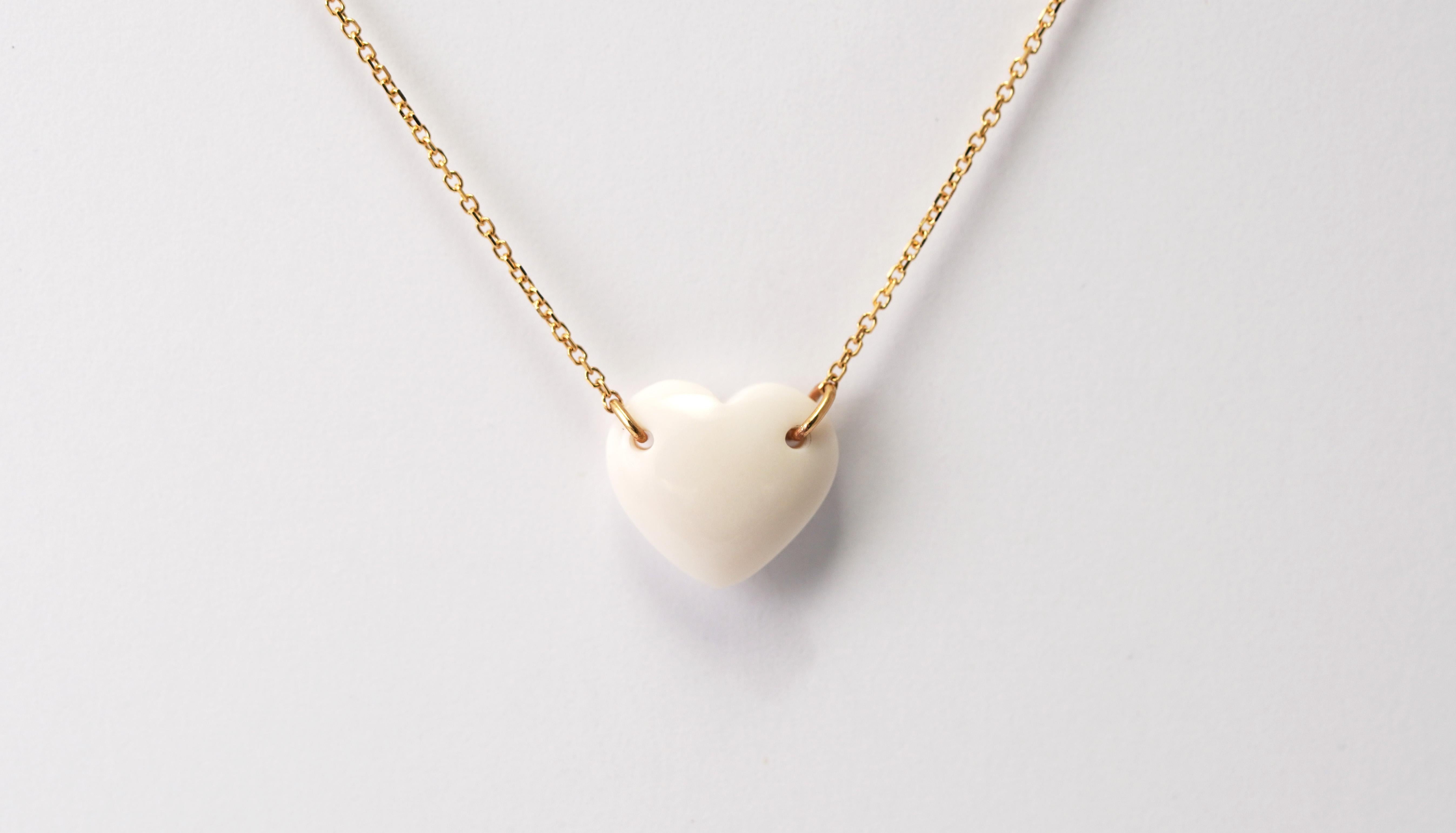Pure elegance shaped into a perfect heart.

This refined necklace, crafted in 18-karat yellow gold, embodies quiet luxury and timeless grace. Its centerpiece — a flawlessly sculpted white Cacholong Opal heart — shines with a soft, milky glow,
