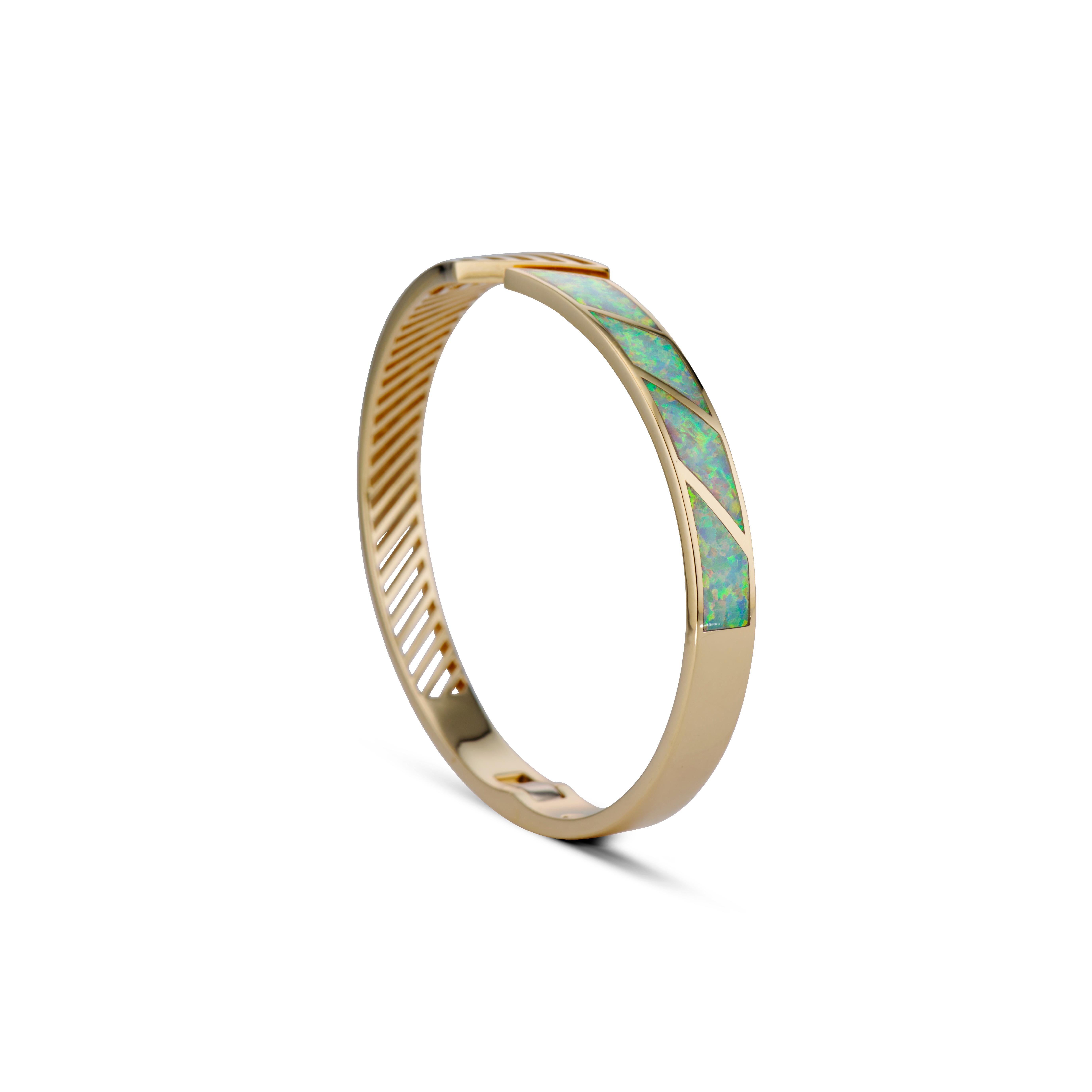 The one-of-a-kind FENESTRA IN-LAY BANGLE beautifully marries intricate white opal inlay craftsmanship with sharp, contrasting linear lines on the opposite side of the bangle. Just as we all possess a variety of facets in our personalities, this
