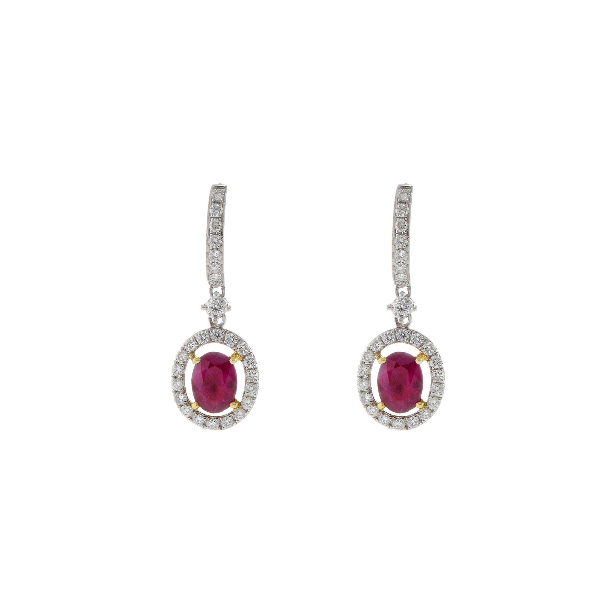 Crafted in a combination of 18KT white and yellow gold, these stunning oval drop halo earrings feature two genuine rubies with a total weight of 2.17 carats. Each vibrant ruby is elegantly surrounded by a halo of high-quality diamonds, boasting G