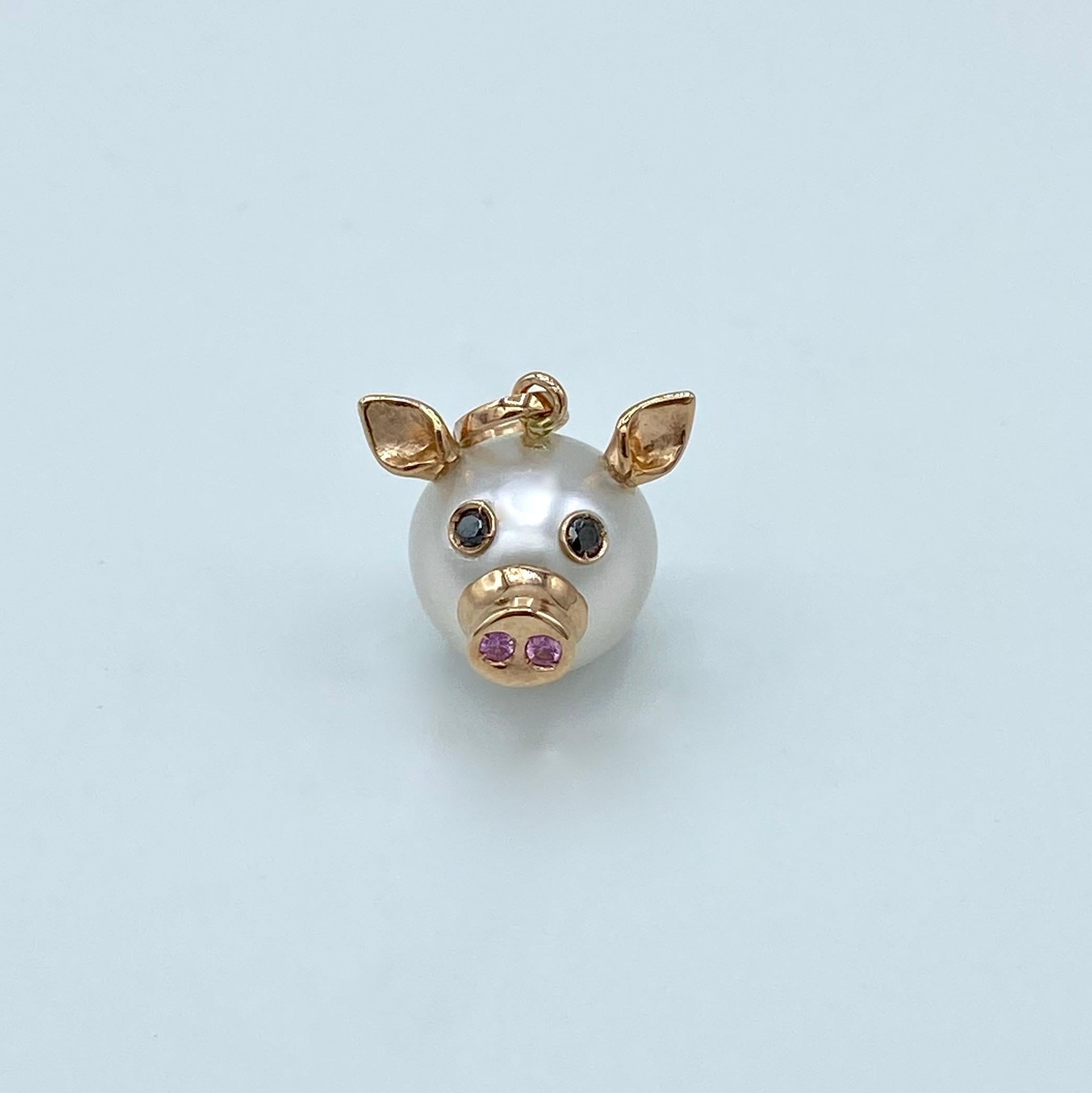 Pig Black Diamond Pink Sapphire 18kt Red Gold Pearl Pendant Necklace
This nice pendant is made with a button Australian pearl. 
It has two ears, two eyes with black diamonds.  
In the holes of its nose there are two pink sapphires encrusted, in