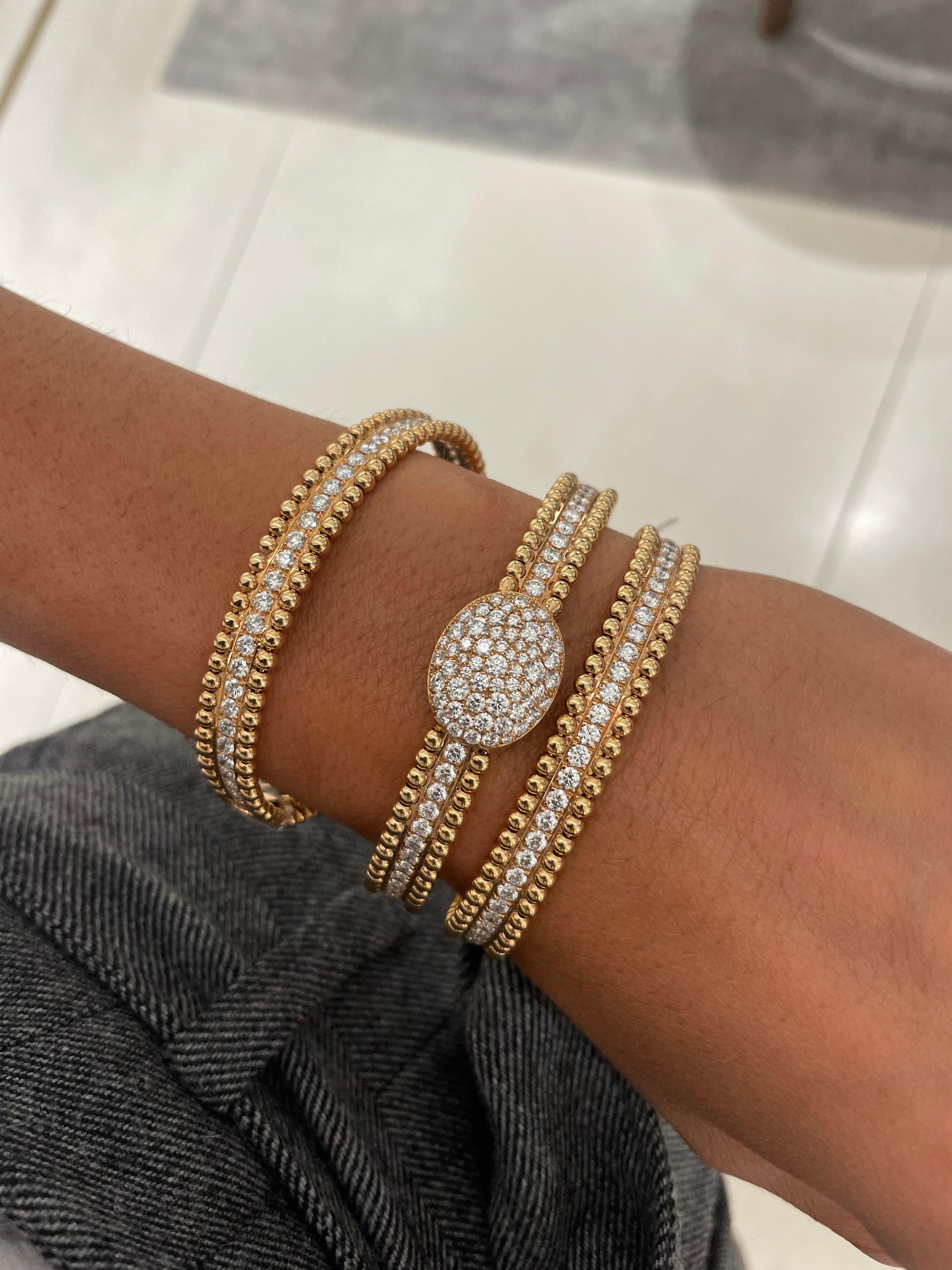 A very classic and easy to wear 18 karat rose gold bracelet. The bracelet is designed with a center row of round brilliant diamonds, with a total weight of 1.85 carats. The bracelet is finished with a beaded edge. It has a hinge on one side which