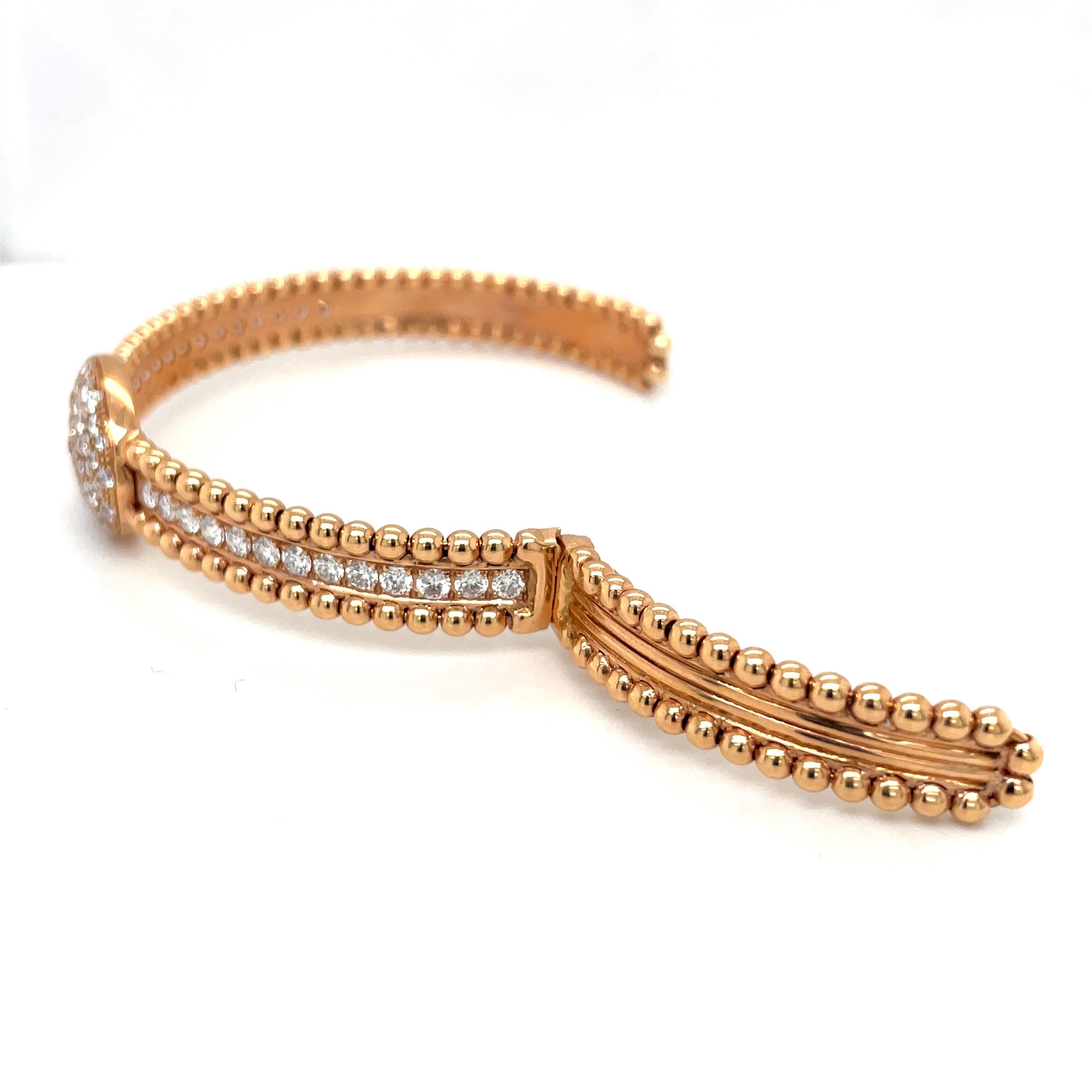 A very classic and easy to wear 18 karat rose gold bracelet. The bracelet is designed with a center row of round brilliant diamonds. An oval pave diamond button is set on the center. The bracelet is finished with a beaded edge. It has a hinge on one