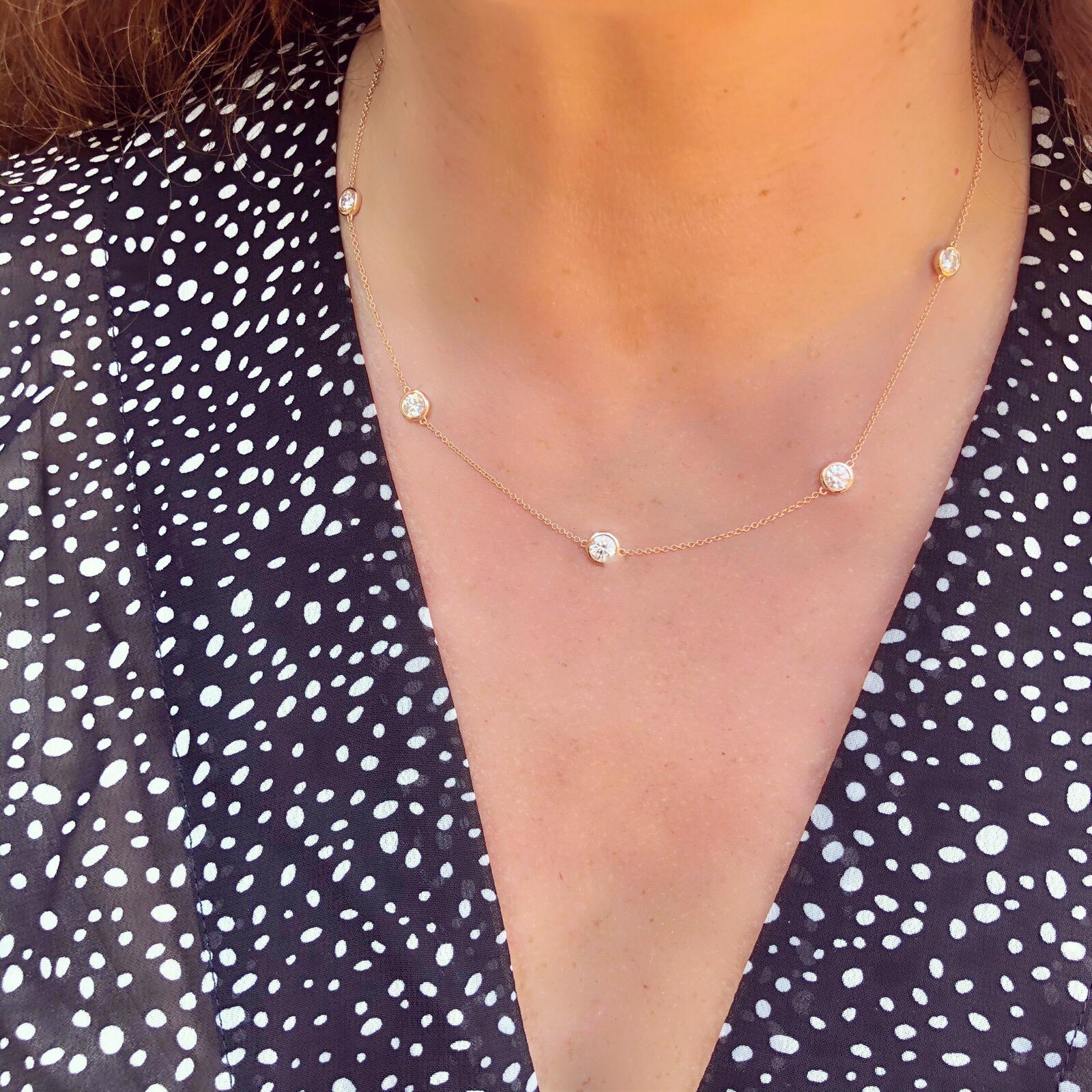 A unique take on a classic style. This 18 karat Rose Gold Diamonds By The Yard Necklace features 5 sparkling white round brilliant cut diamonds expertly bezel set on an adjustable chain. With two loops perfectly situated on the necklace, this