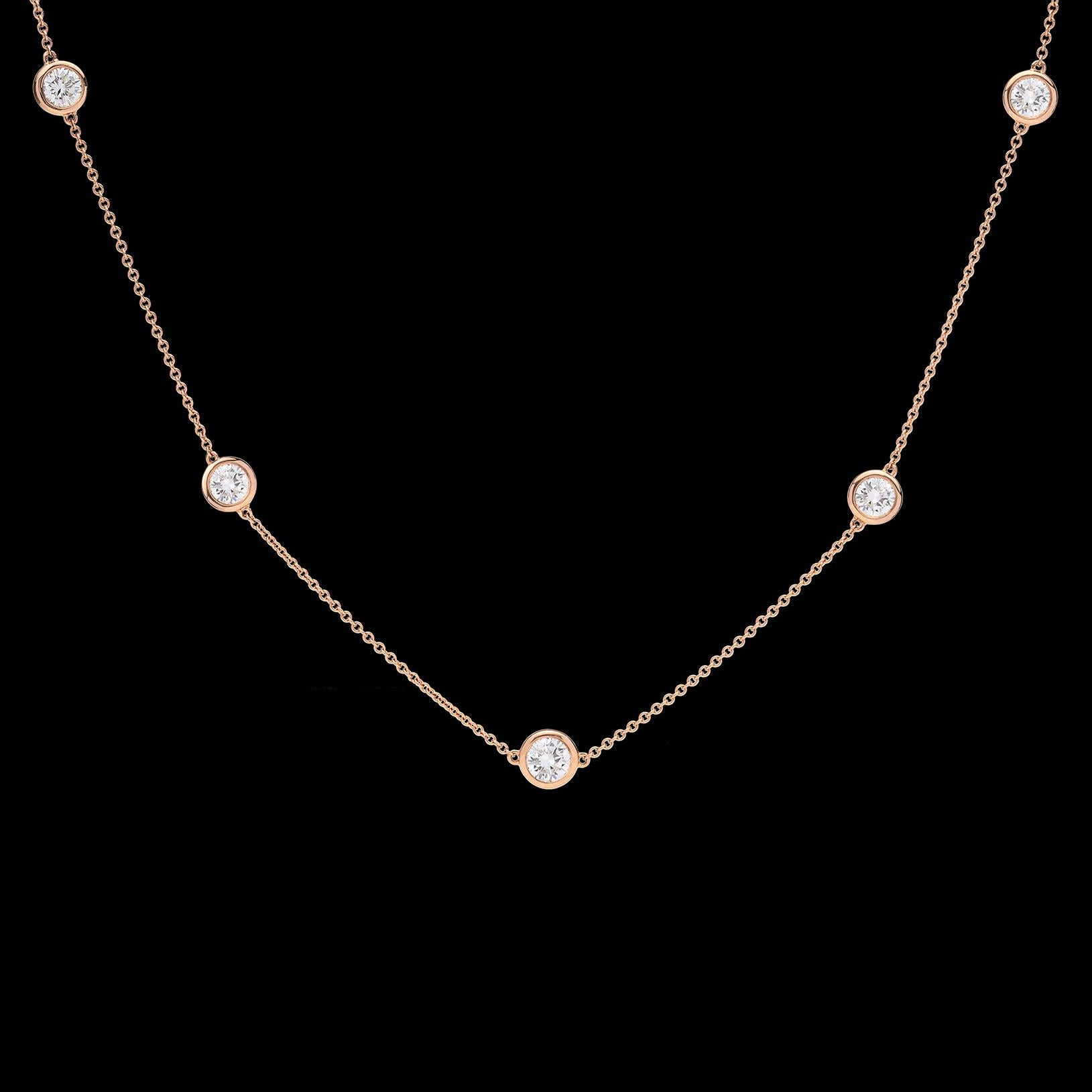 A unique take on a classic style. This 18 karat Rose Gold Diamonds By The Yard Necklace features 5 sparkling white round brilliant cut diamonds expertly bezel set on an adjustable chain. With two loops perfectly situated on the necklace, this