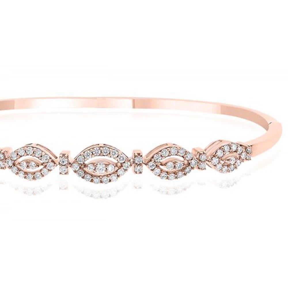 18kt rose gold diamond bangle is sightly oval in shape to fit close to the wrist. Works great as an independent piece or can stack. (We also have in yellow and white gold). There are 79 round brilliant diamonds and they total .72ct. 

The bangle is