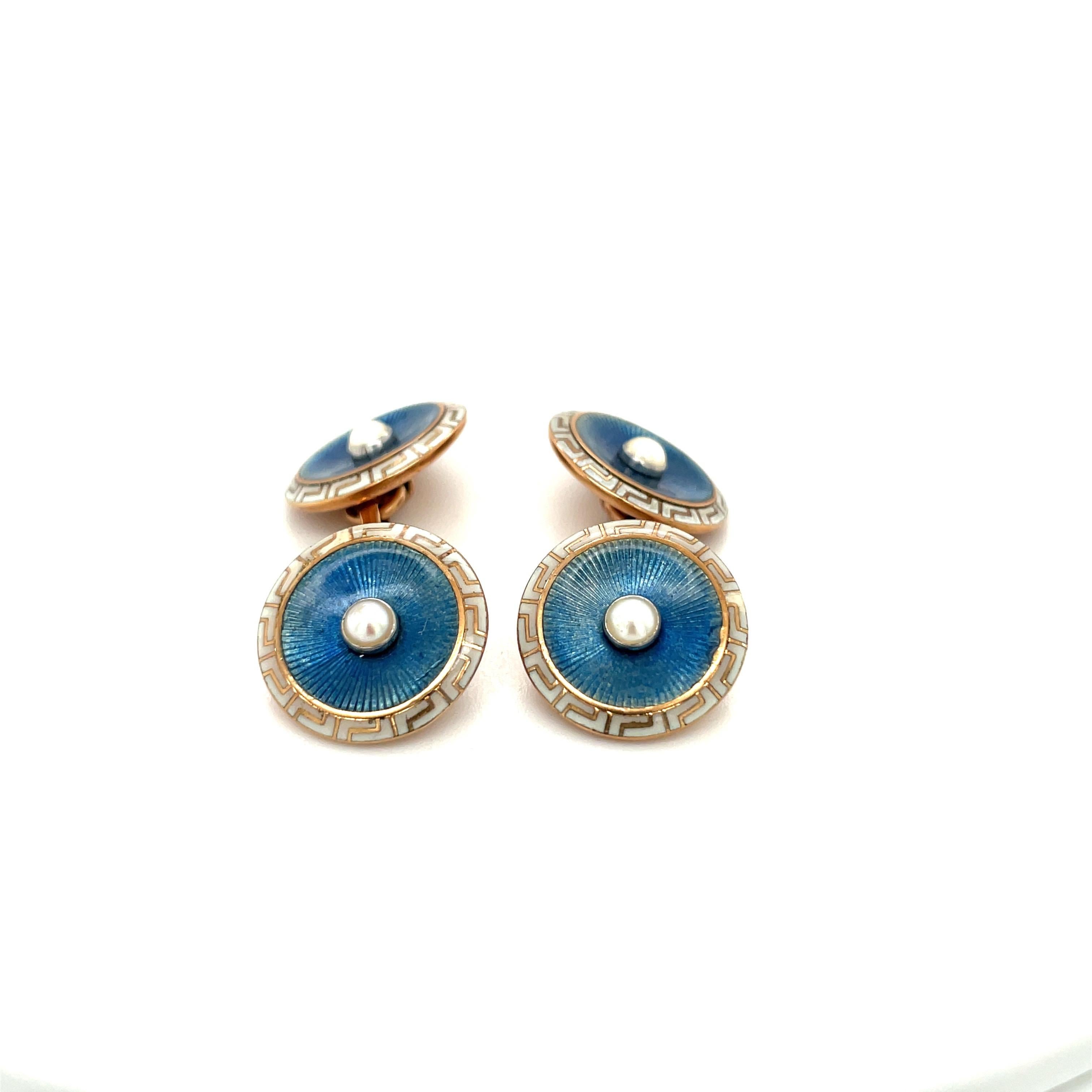 Classic 18 karat rose gold and enamel cuff links. The round cuff links are crafted with a chambray blue enamel center trimmed with a cream enamel with a Greek key design. A small pearl centers each of the 4 rounds.