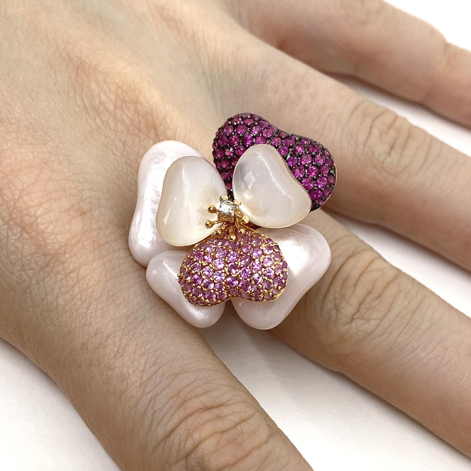 Flower theme ring made of 18 kt rose gold .with mother-of-pearl petals and pavé brilliant-cut pink sapphires for ct.0.92 and pavé rubies for ct.1.53 and central natural diamond for ct.0.04
-------------------------------------------------

Important