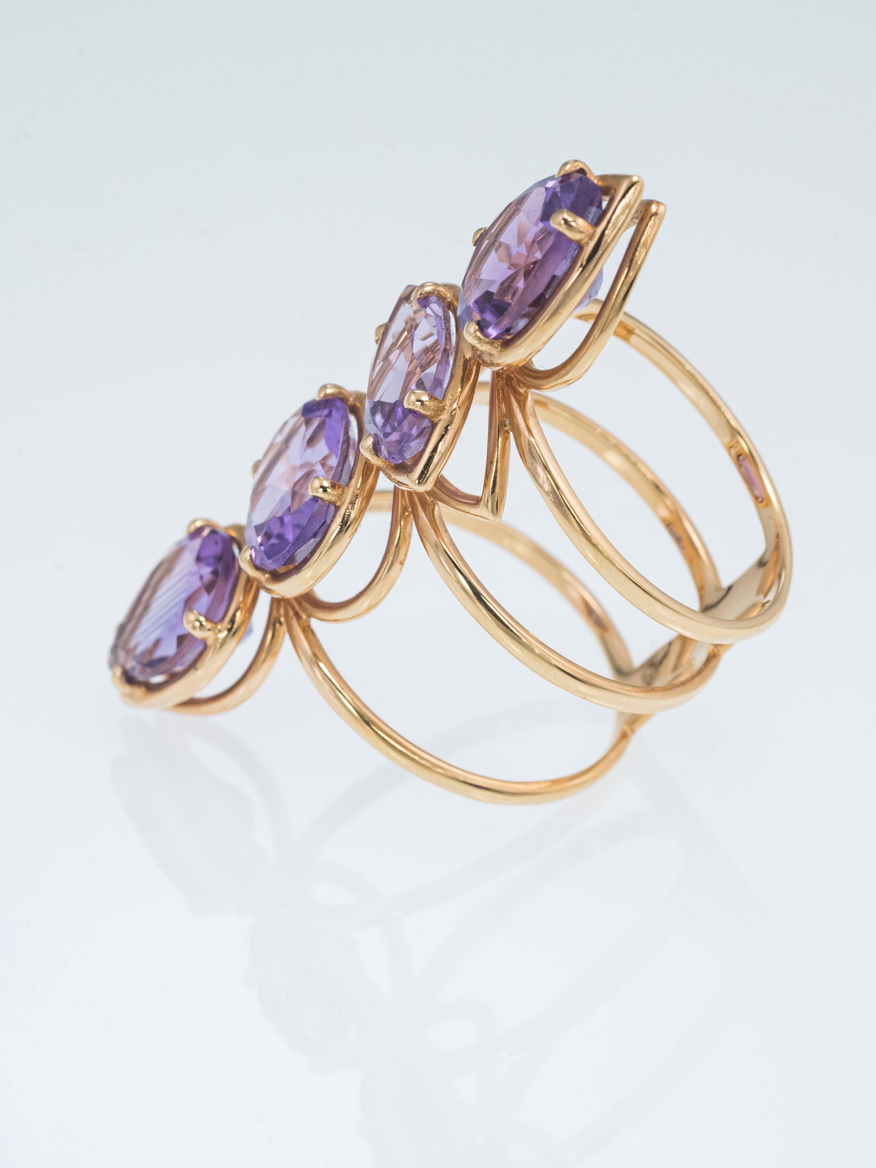 This Etho Maria ring has a fancy, light and elegant design.
It's made up by three different kind of Amethyst cut. Two stones have a pear cut, one has an oval cut and one has a marquise cut for a total weigh of ct  7.70.

Size 6 1/2 This ring is