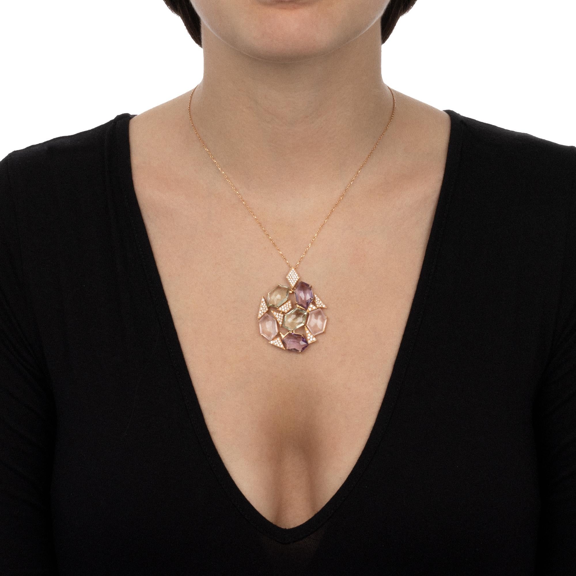 An handmade contemporary jewellery piece with a modern design that is bold and sophisticated at the same time. The distinctive asymmetrical setting of the pendant lets the gemstones sparkle bright, drawing the light around your neckline with the