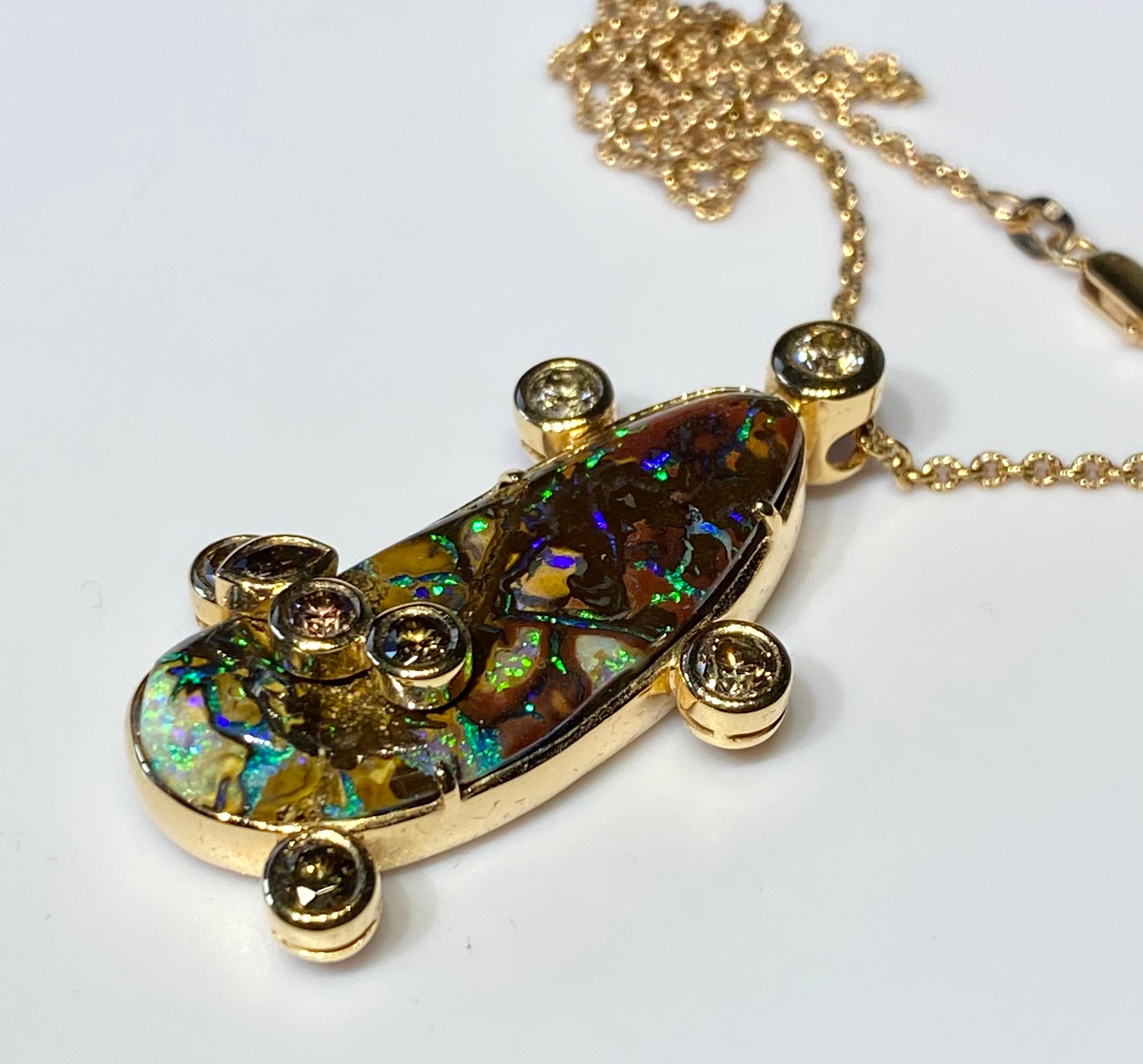 18kt Rose Gold Pendant with Cognac Diamonds & Australian Boulder Opal Cabochon.
This Pendant is One and three quarter inches long by one inch wide and hangs on a 20 Inch Rose Gold Chain with a Lobster Claw Clasp.
18kt Rose Gold Weight 13 Grams (not