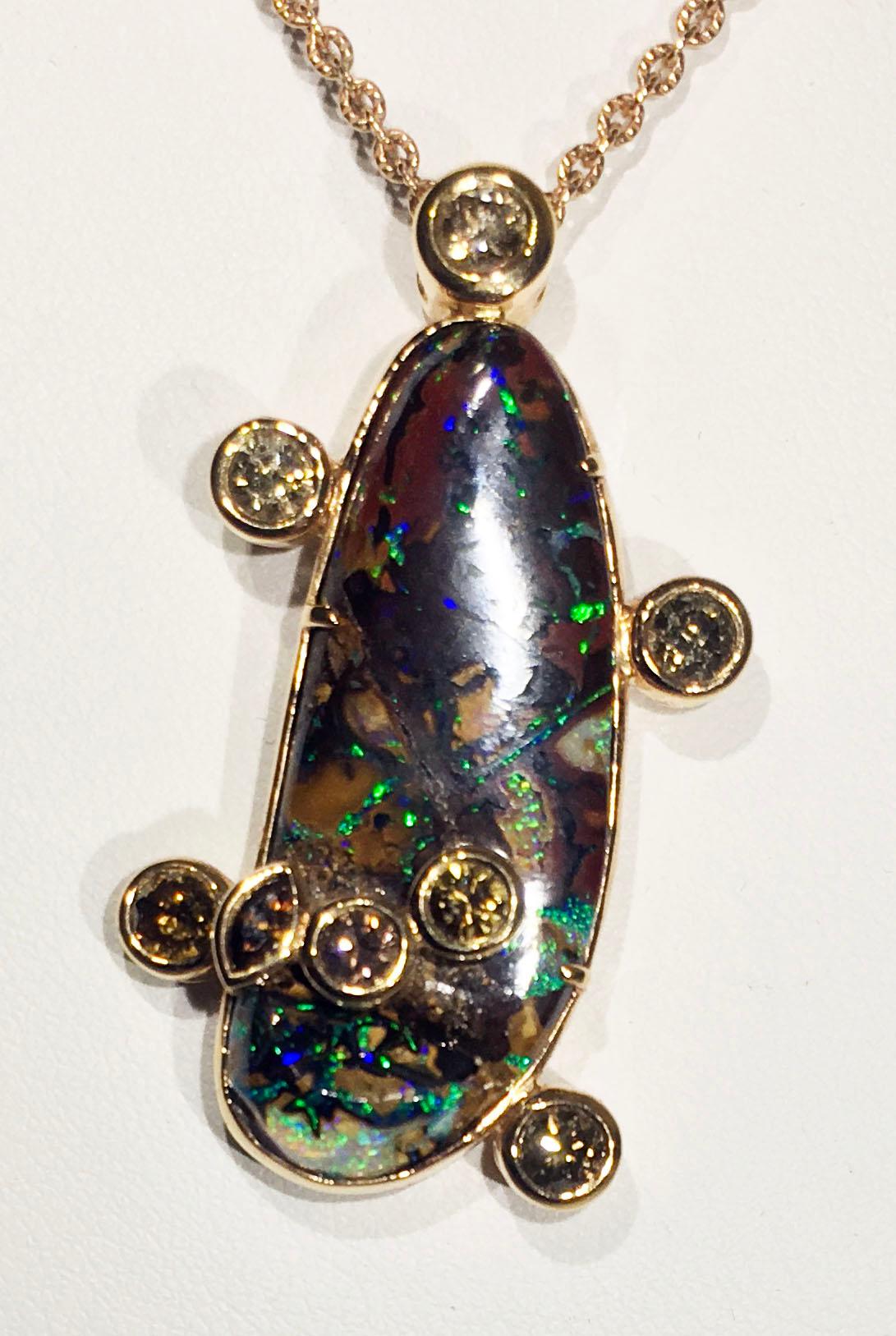 Kary Adam Designed, 18kt Rose Gold Pendant with Cognac Diamonds & Australian Boulder Opal.
This Pendant is 1 1/8” long by 1” wide and hangs on a 20 Inch Rose Gold Chain with a Lobster Claw Clasp.
18kt Rose Gold Weight 13 Grams (not Including Chain),