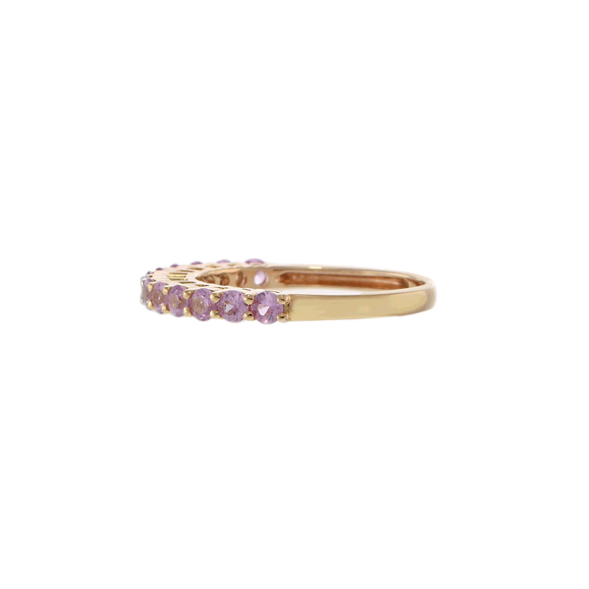 Delicate and feminine, this 18K rose gold band features a series of round-cut pink sapphires totaling approximately 1.00 carat, highlighted by a sparkling diamond accent of approximately 0.05 carats. The soft blush tones of the sapphires are