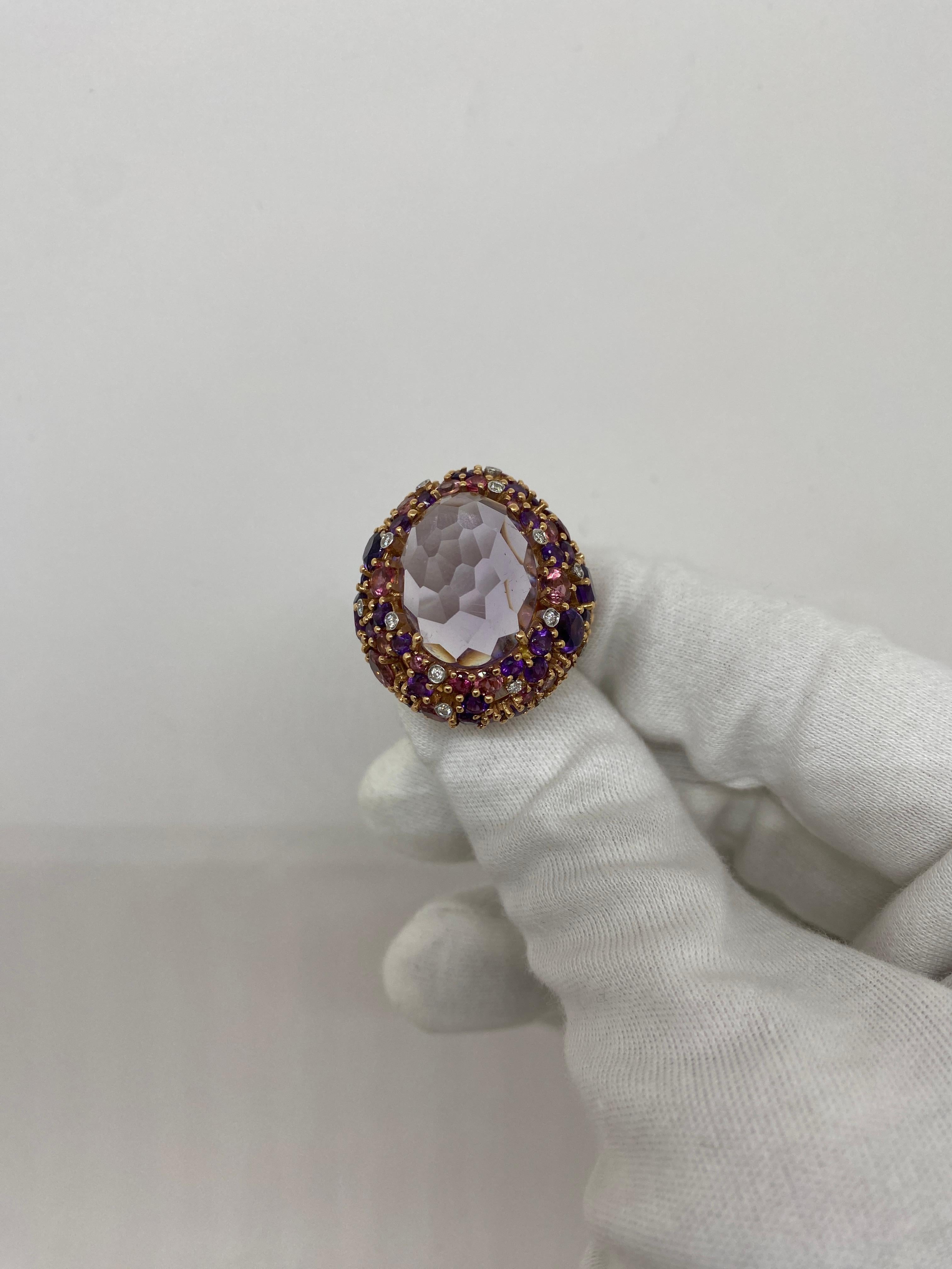 18 kt rose gold ring with central oval-cut amethyst surrounded by pink sapphires, amethysts and white natural round-cut diamonds

Welcome to our jewelry collection, where every piece tells a story of timeless elegance and unparalleled craftsmanship.