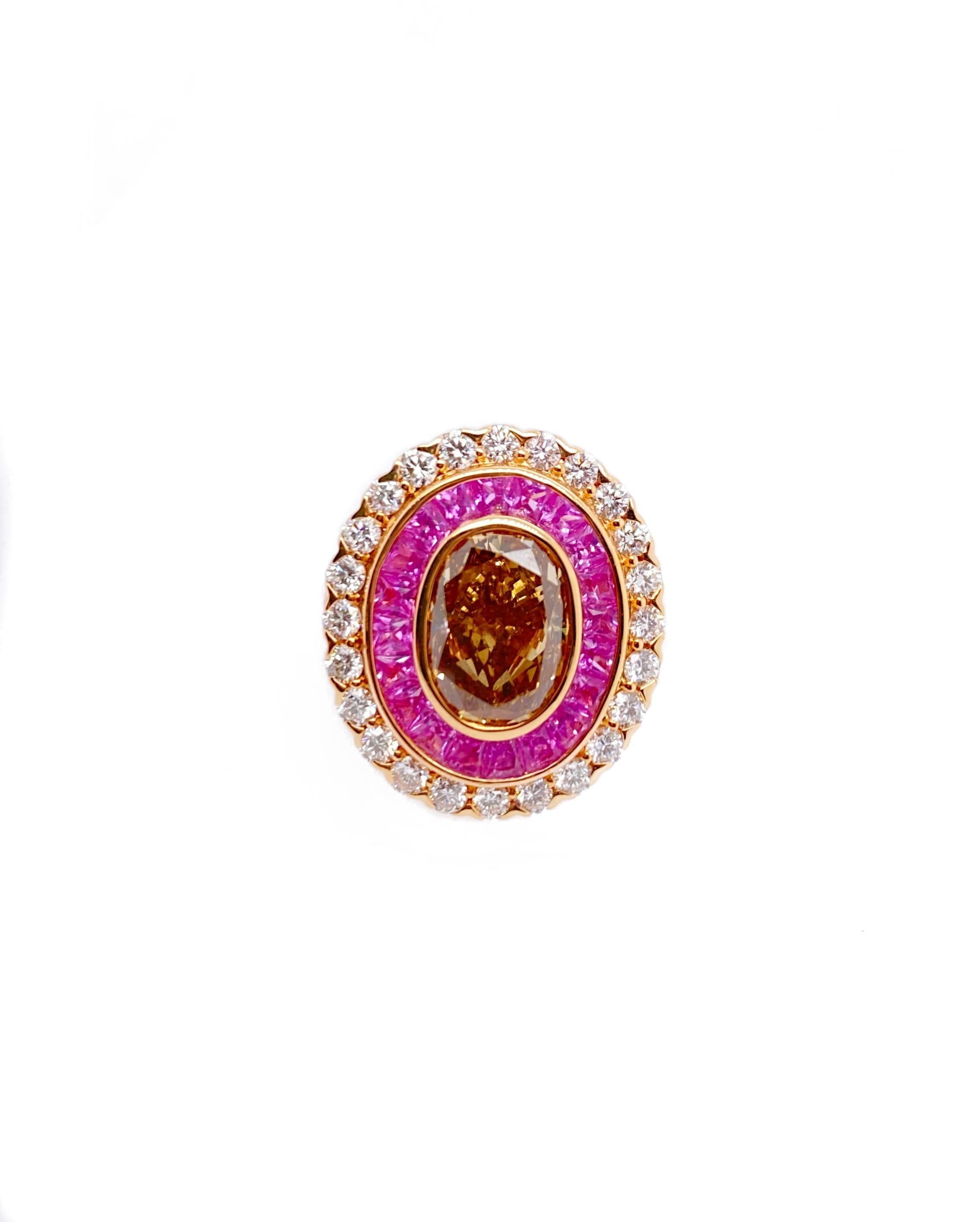 18kt rose gold ring with a center igi certified oval fancy brown vs2-si1  (ovc245) set in diamond and pink sapphire setting with 3.31ct diamonds around in halo setting split shank.
