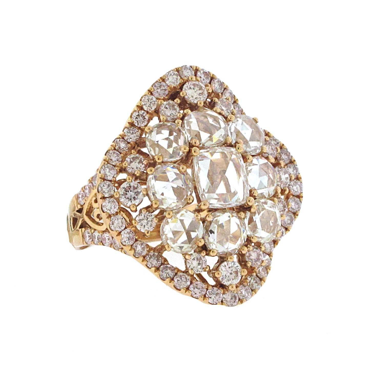 Such a gorgeous ring. Set in 18kt rose gold, this rose cut diamond ring has over 5 carats total weight. Weight is stamped in the bottom of the ring. Large diamonds have a total weight of 3.40 carats and there is 1.64 carats of smaller diamonds.
