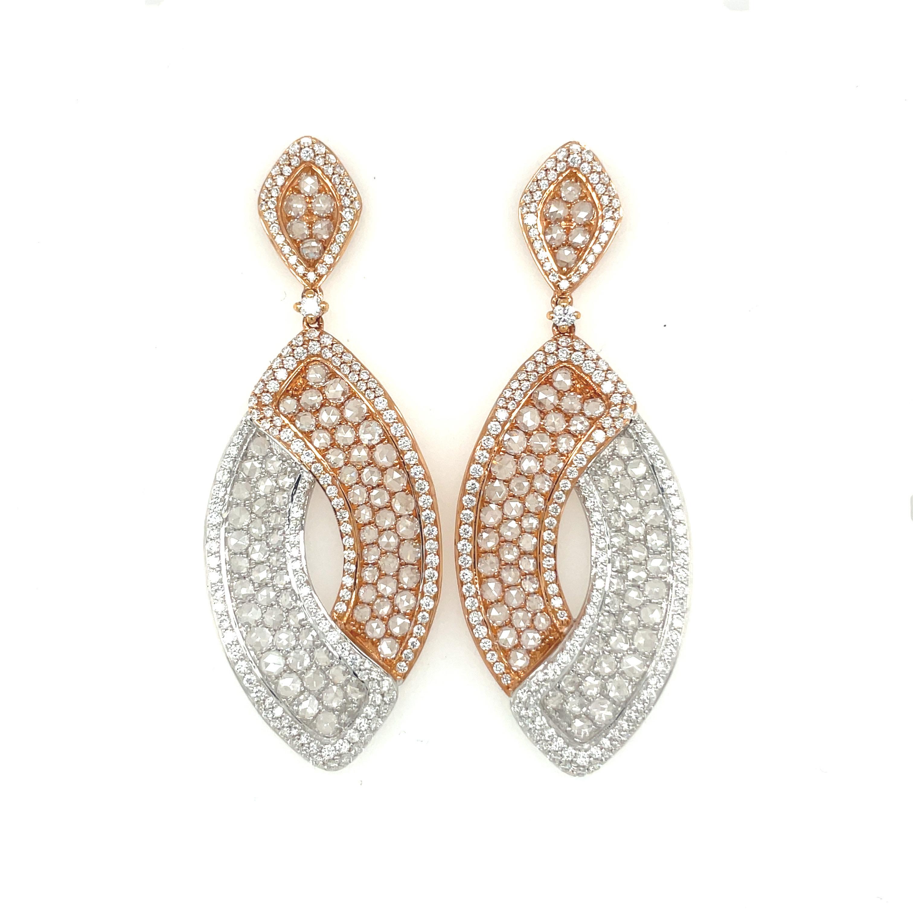 Set in 18-karat rose and white gold, these gorgeous and versatile earrings are composed of 2.30 carats of round diamonds surrounding 3.94 carats of rose-cut diamonds.
The sparkle of the diamonds are enhanced by the combination of diamond cuts, as