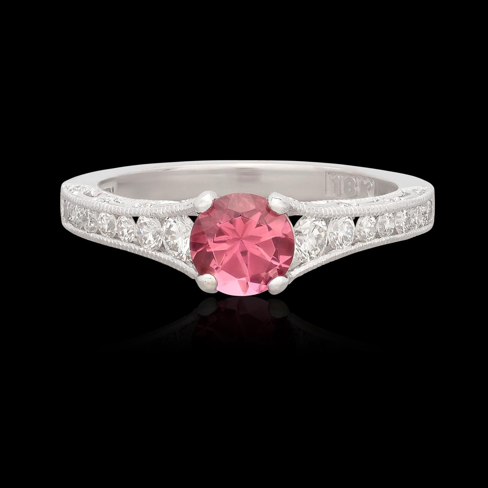 Perhaps the perfect pop of color! One exquisite purplish pink tourmaline weighing 0.83 carats is perfectly set with four prongs in a gorgeous 18 karat white gold ring by Tacori. Accenting the white gold ring are 32 perfectly matched diamonds for