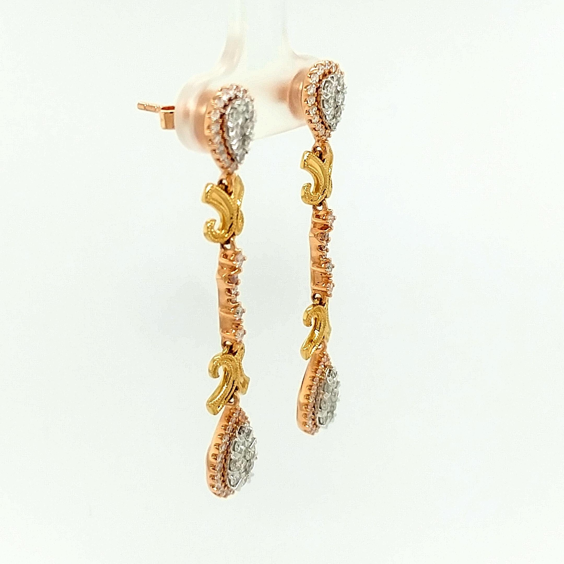 A beautiful pair of 18kt yellow, white and rose gold chandelier earrings featuring 1.30 carats of round brilliant cut diamonds. The diamonds are prong and pressure set. The earrings have a push back closure with an omega back clip. The country of