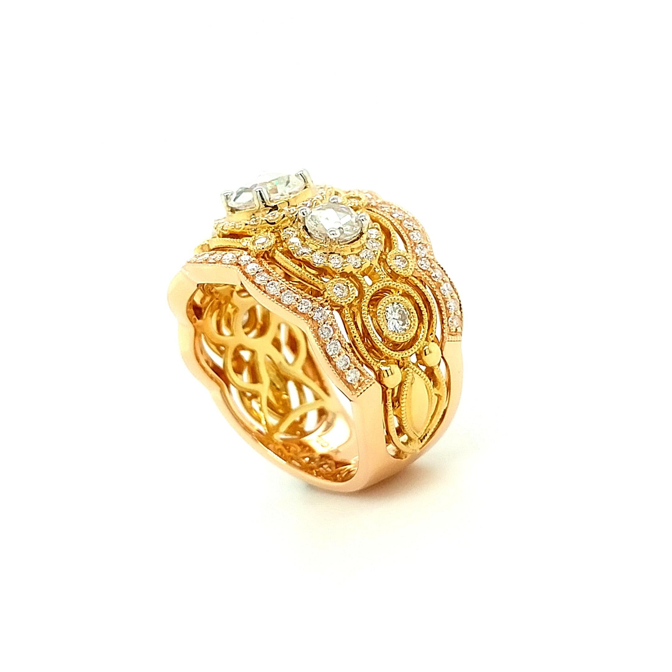 A beautiful three stone 18Kt White, Yellow, and Rose Gold cocktail ring set with 1.89 carats of round brilliant and rose cut diamonds. There are 0.77 carats of round brilliant cut diamonds and three rose cut diamonds weighing a total of 1.12 carats.