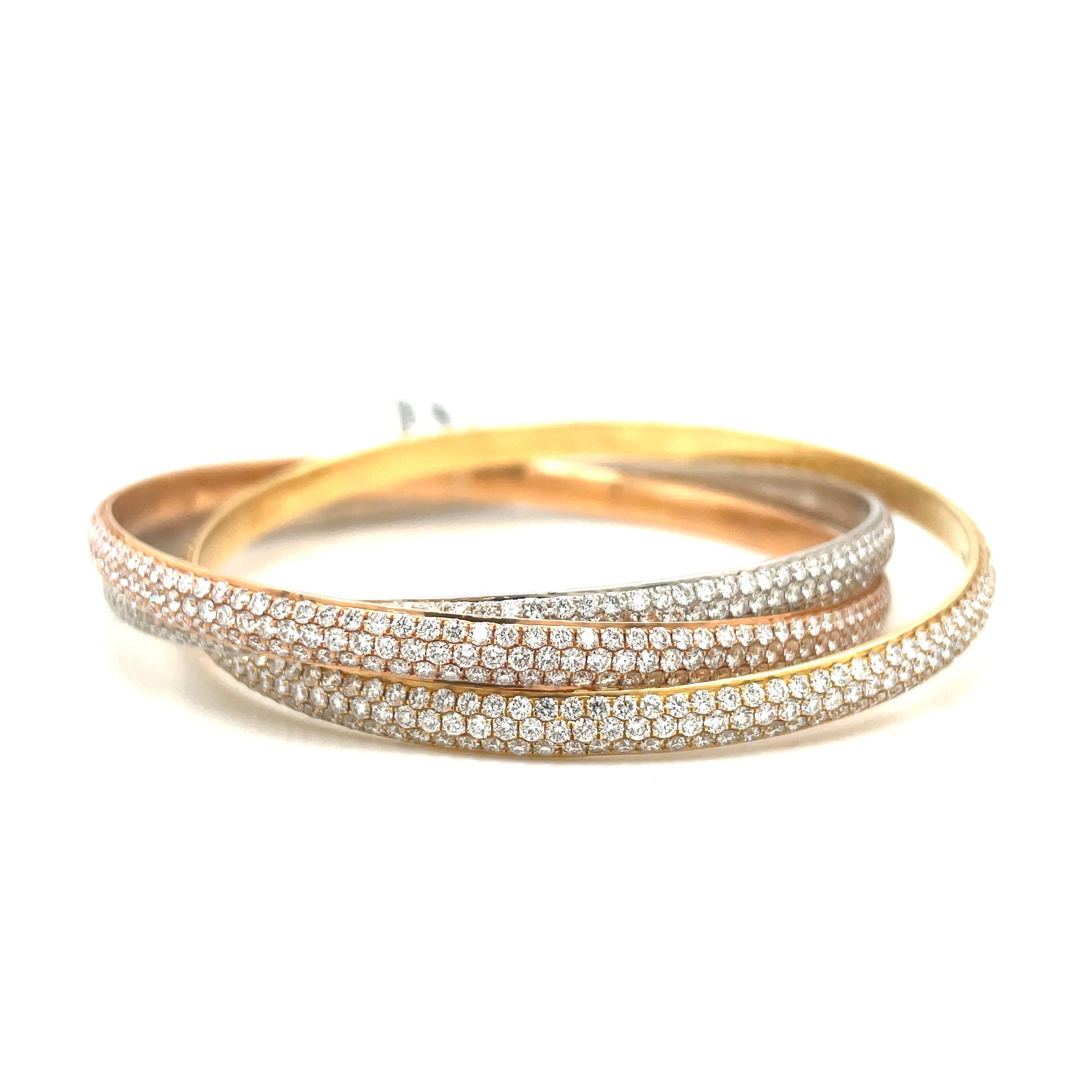 Designed in 18 karat yellow, rose and white gold, this rolling bangle bracelet remains classic. The bangle bracelet is set with 17.05 carats of round brilliant diamonds. Each bracelet has 3 rows of diamonds.
The inside measurement is 2.5 
