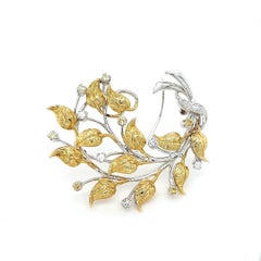 Broche fleur en or blanc et jaune 18kt avec 0.90ct de diamants