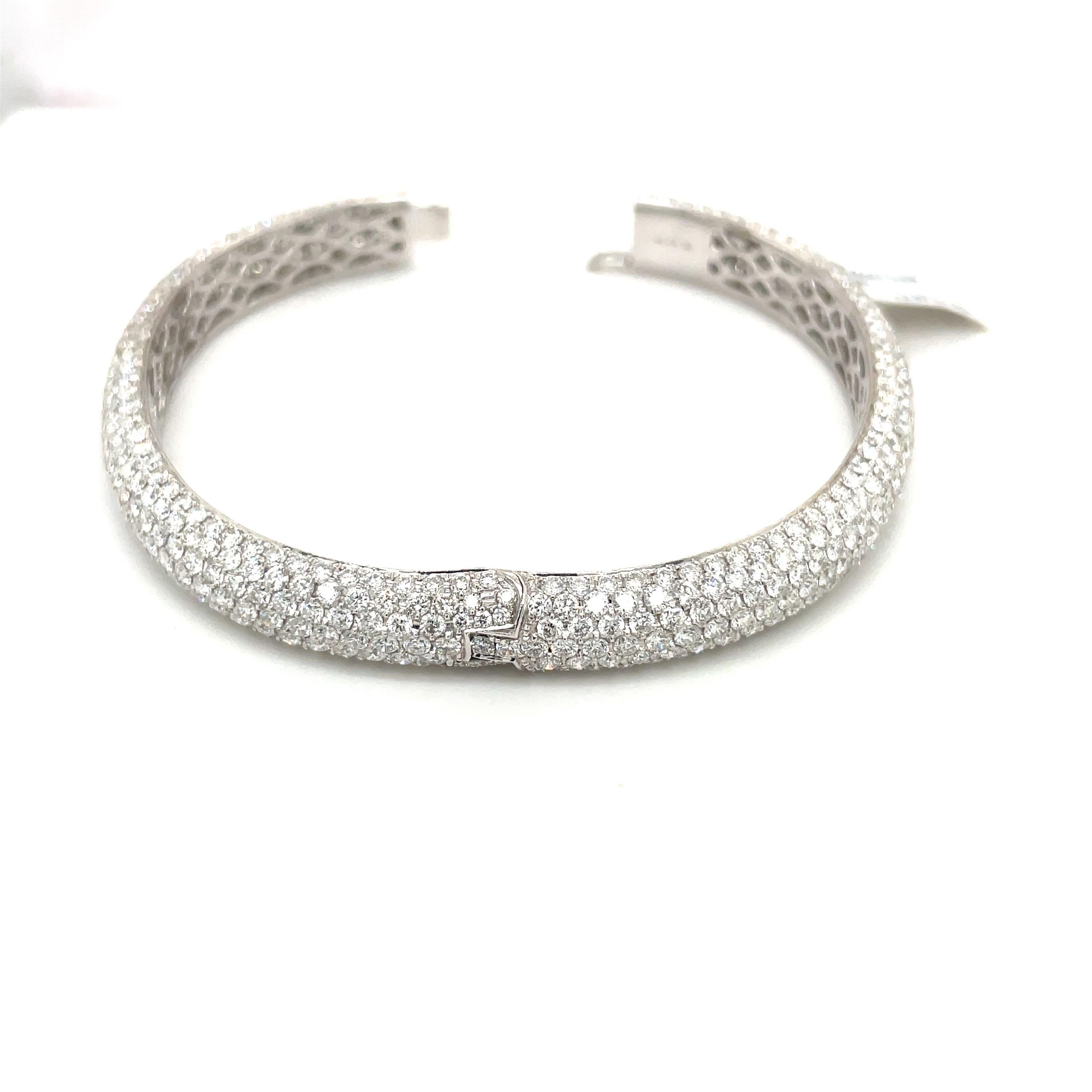 Magnificently set 18 karat white gold pave' diamond bangle bracelet. The oval shaped bracelet has a total of 621 round brilliant diamonds with a total weight of 15.68 carats. The beauty of this bracelet is the oval shape, which  sits so comfortably