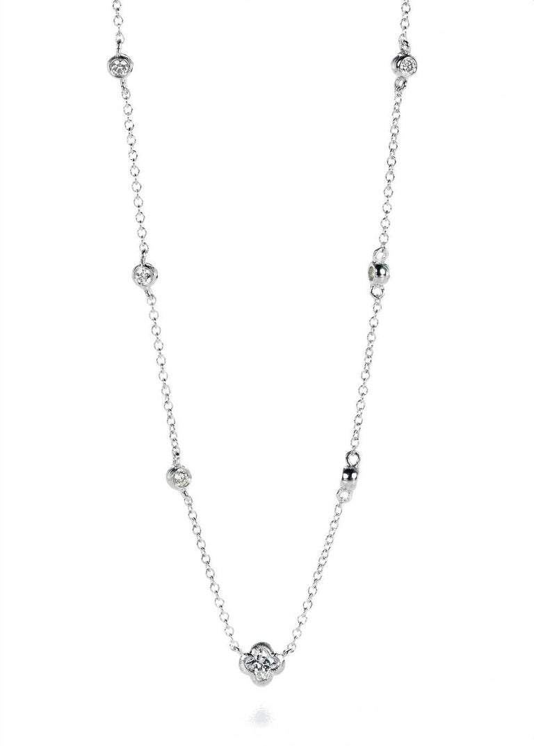 18KT white gold station diamond round and flower necklace. 1  LILY CUT ® flower shape diamond H color VS SI clarity  0.18 cts . additional 0.20 ct round diamond accent .   17 inch with a link to shorten to 16 inch . 