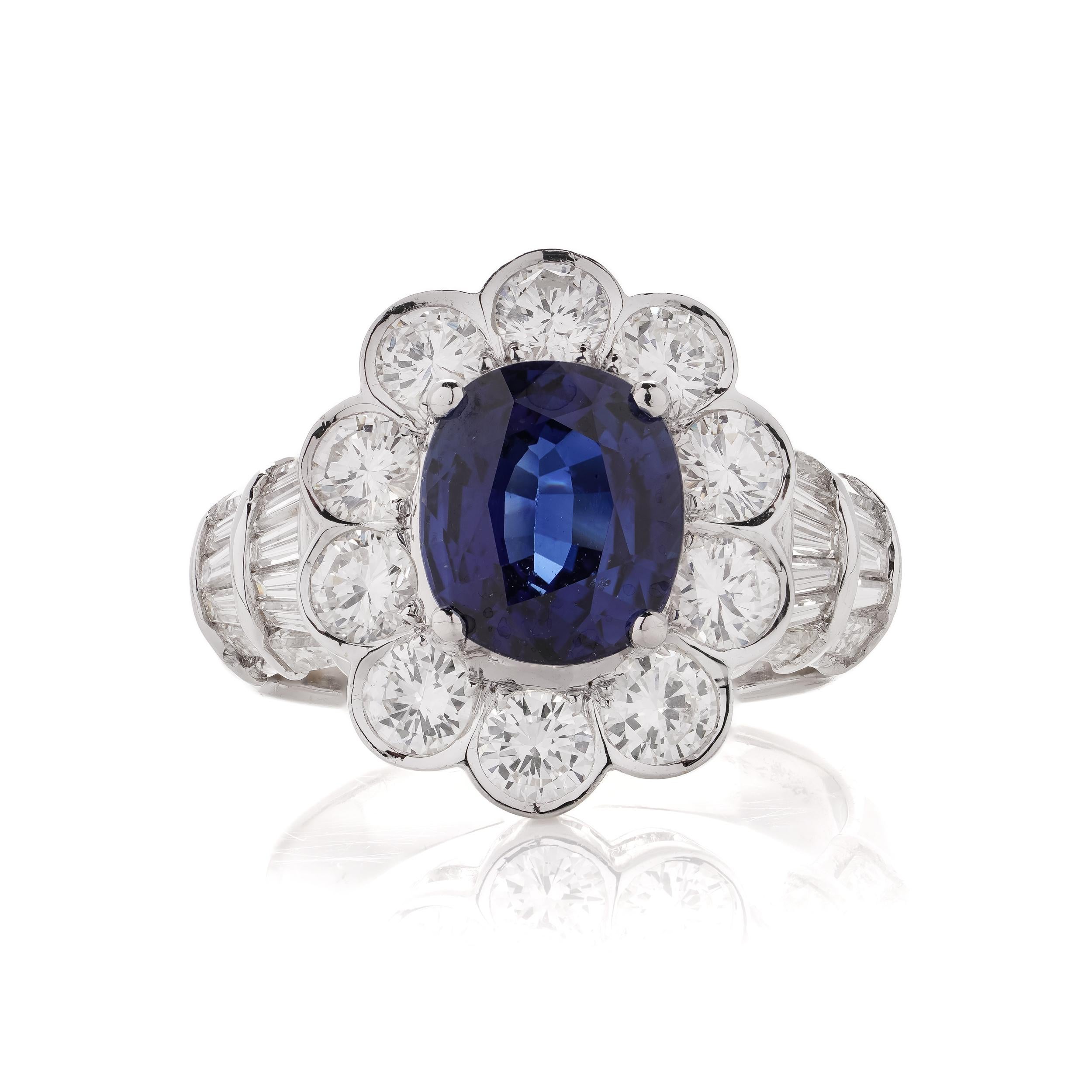 18kt. white gold 3.30 carat Oval Blue Sapphire Cluster ladies ring, surrounded by round 1.80 carats of brilliant diamonds accented with 0.70 carats of  baguette and tapered baguette diamonds. 

Hallmarked for 750 ( 18kt. gold standard )

* Please