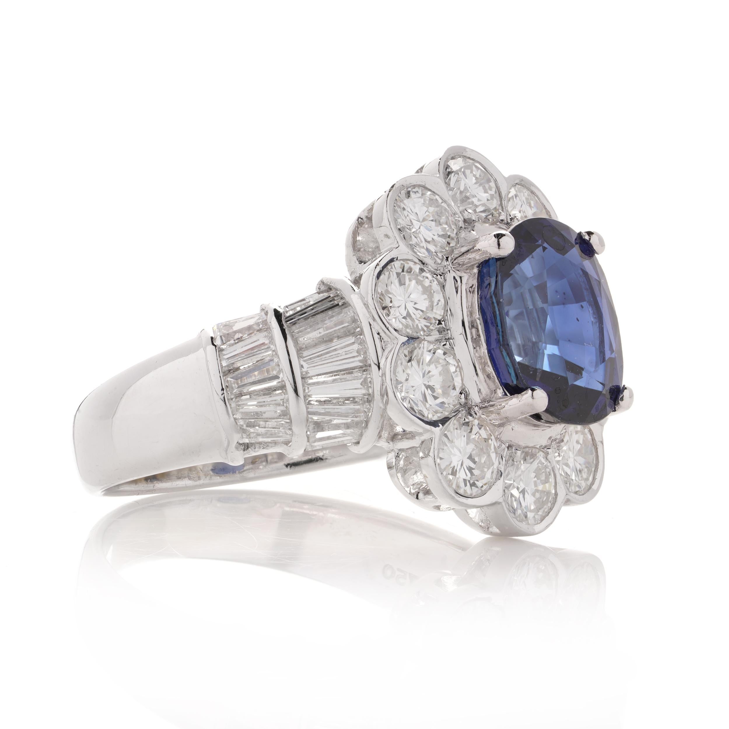 Oval Cut 18kt White Gold 3.30 Carat Oval Blue Sapphire Cluster Ladies Ring with Diamonds For Sale