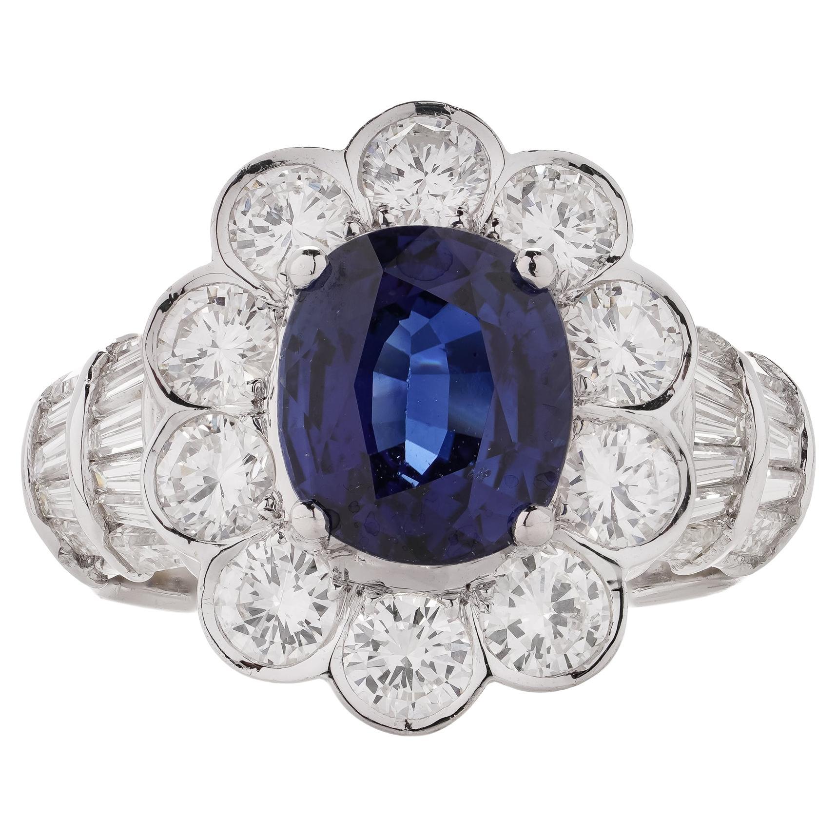 18kt White Gold 3.30 Carat Oval Blue Sapphire Cluster Ladies Ring with Diamonds For Sale