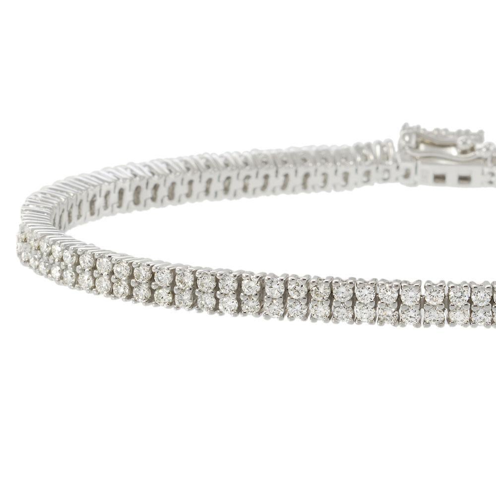 Refinada y radiante, esta pulsera tenis de oro blanco de 18 quilates exhibe dos deslumbrantes filas de diamantes redondos talla brillante que suman 2,83 quilates. El diseño aerodinámico y la excepcional artesanía confieren a esta silueta clásica una