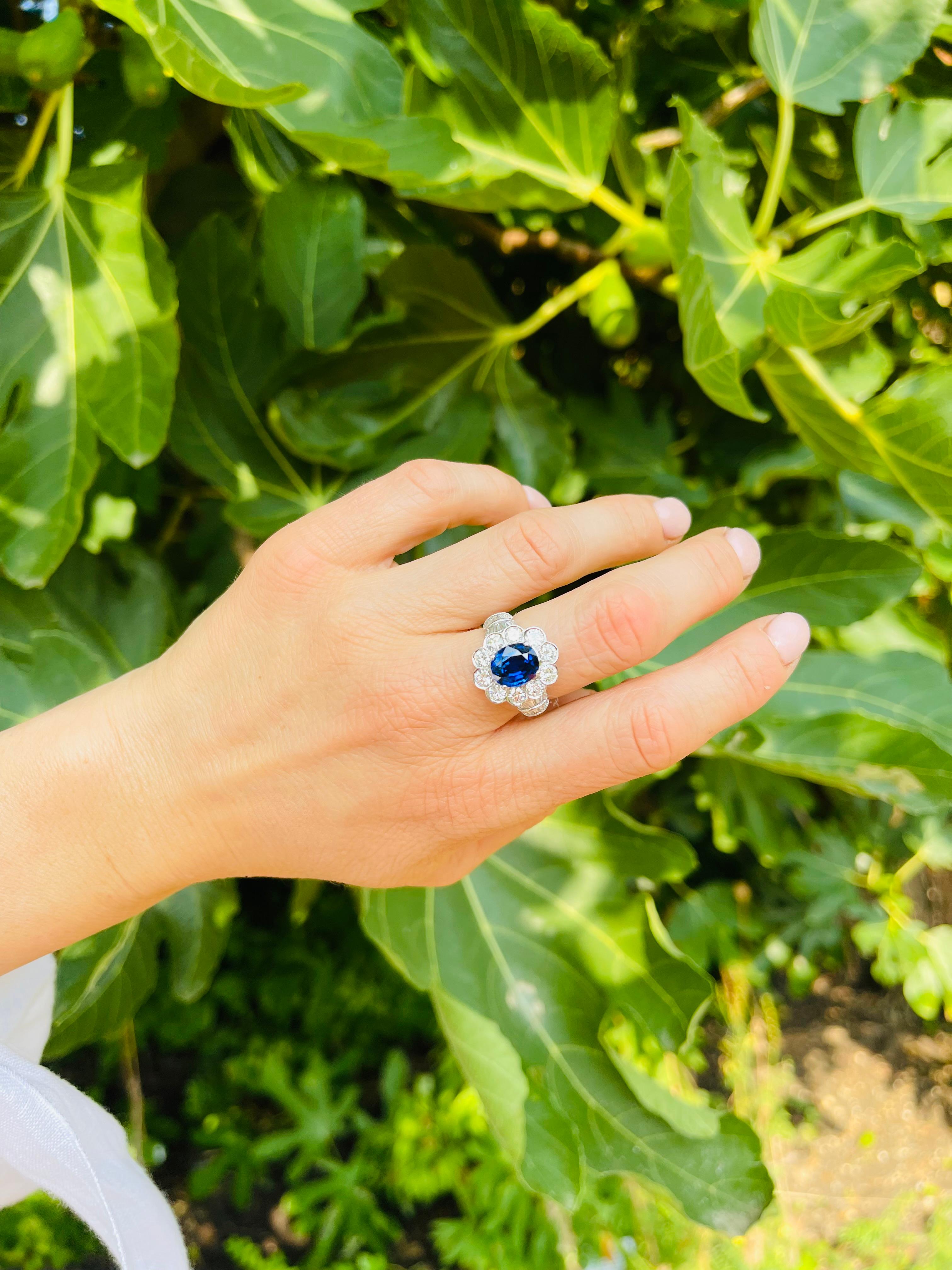 18kt. white gold 3.30 carat Oval Blue Sapphire Cluster ladies ring, surrounded by round 1.80 carats of brilliant diamonds accented with 0.70 carats of  baguette and tapered baguette diamonds. 

Hallmarked for 750 ( 18kt. gold standard )
Dimensions -