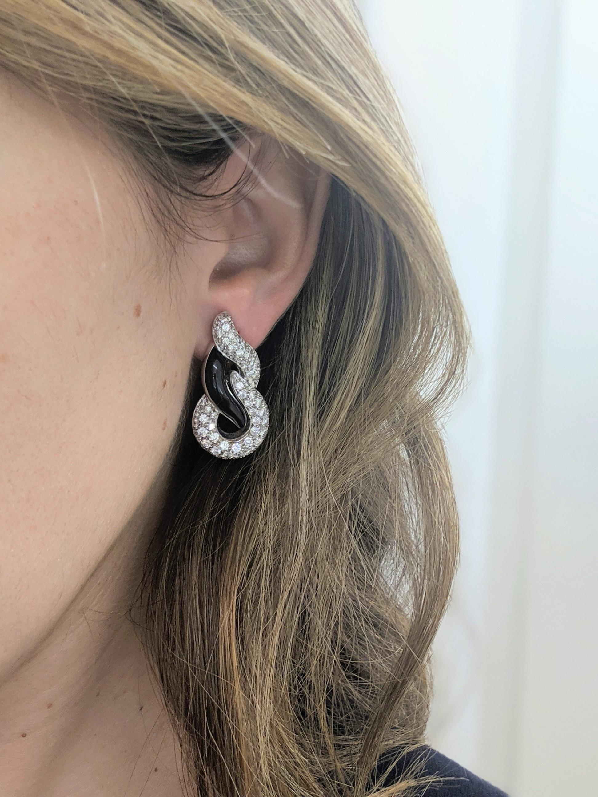 Lovely and elegant would best describe these earrings. Crafted entirely in 18 karat white gold and set with round brilliant pave diamonds and black onyx. The beautiful curves of the earrings allow them to sit beautifully, framing the face.  The