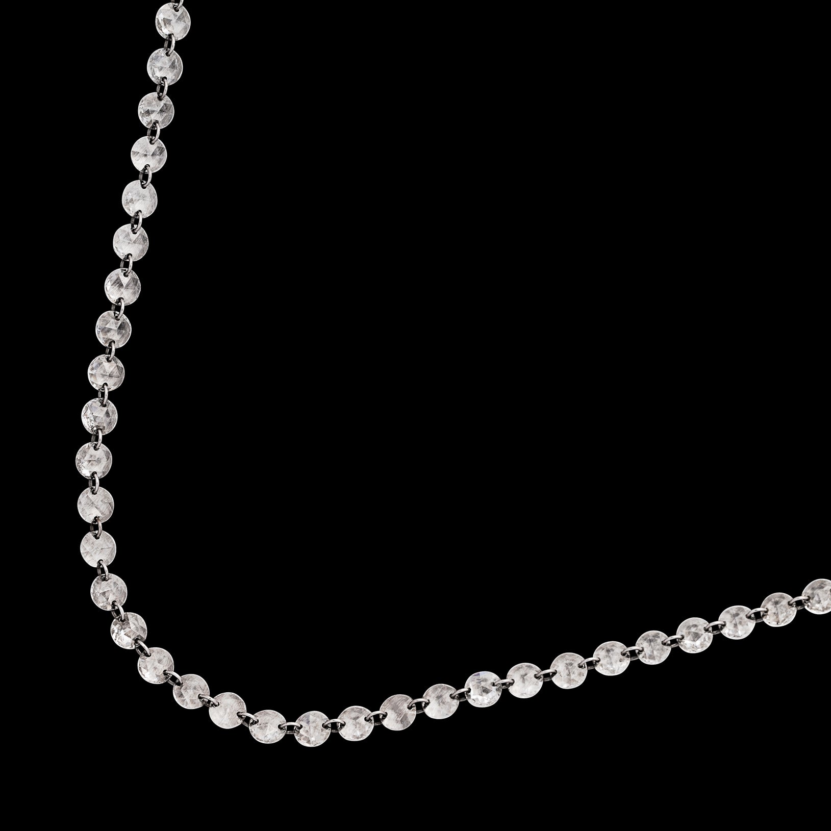 An absolute beauty! This 18 karat white gold necklace features 131 crystal clear diamonds for a total of 5.79 carats. These unique flat round cut diamonds are woven together directly through each stone, giving the illusion that the diamonds are