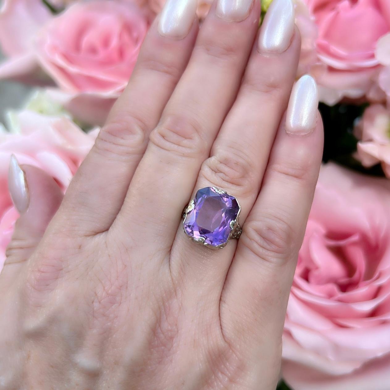 They truly don't make them like they used to! This incredible antique 18 karat white gold ring features a vibrant purple 7 carat amethyst perfectly set in one of the more gorgeous rings you're likely to see featuring hand-engraving and beautiful