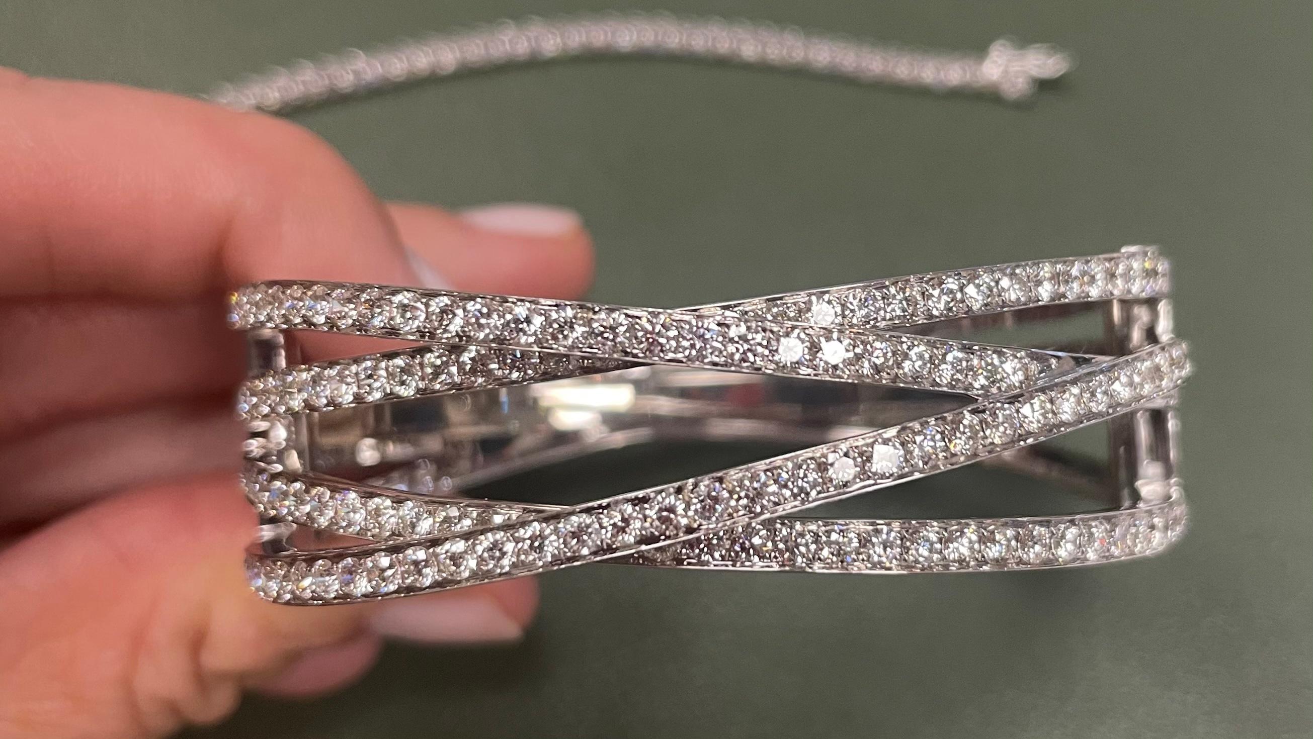 Exceptionally well made diamond bangle bracelet featuring 136 round brilliant diamond for a total carat weight of 5.91cts. The diamonds are estimated to be of G/H color and VS clarity set in 18kt white gold and stamped accordingly.