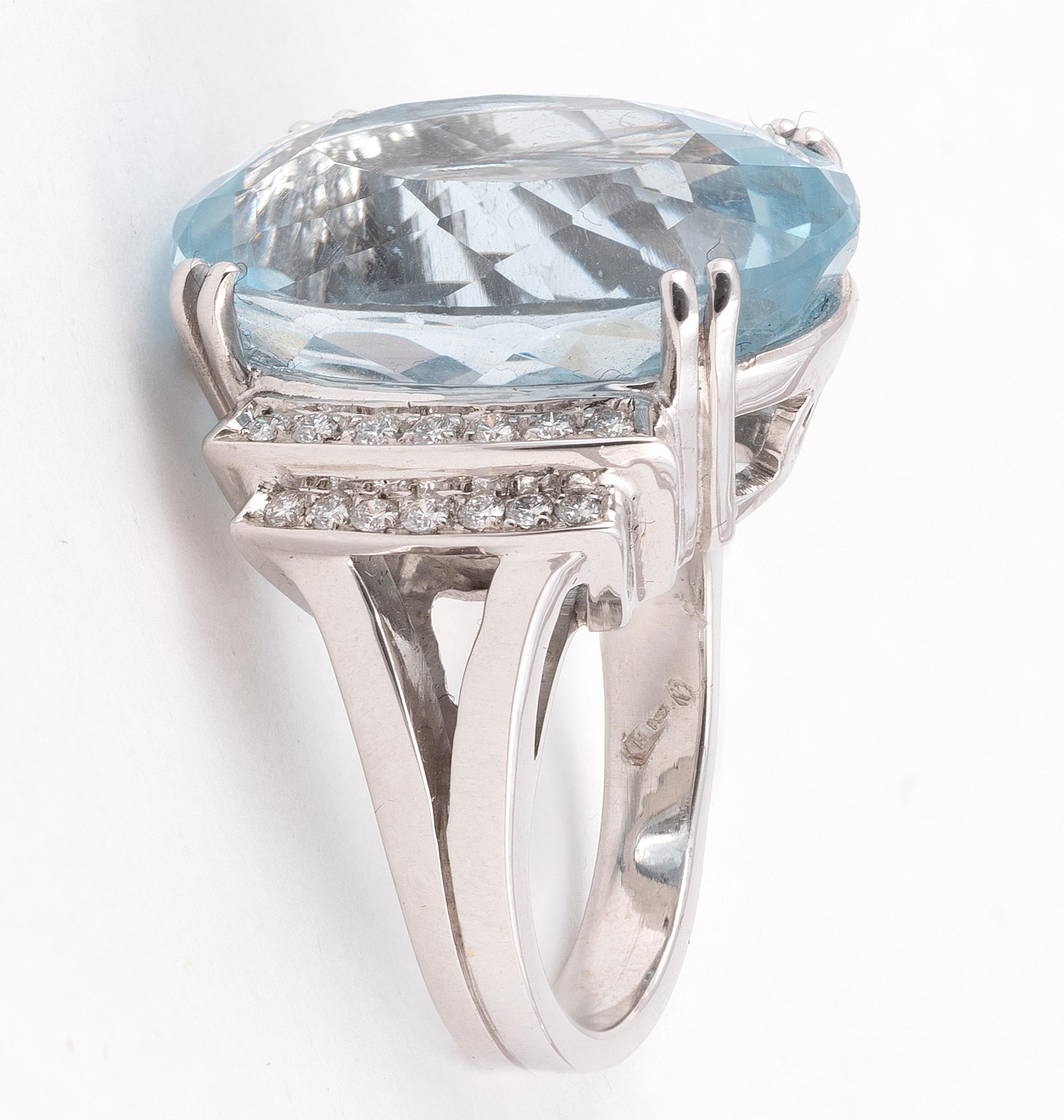 set in the center with an oval-shaped aquamarine weighing approximately 25cts, and accented by round diamonds weighing approximately 1.45cts, mounted in 18k white gold, size 8
