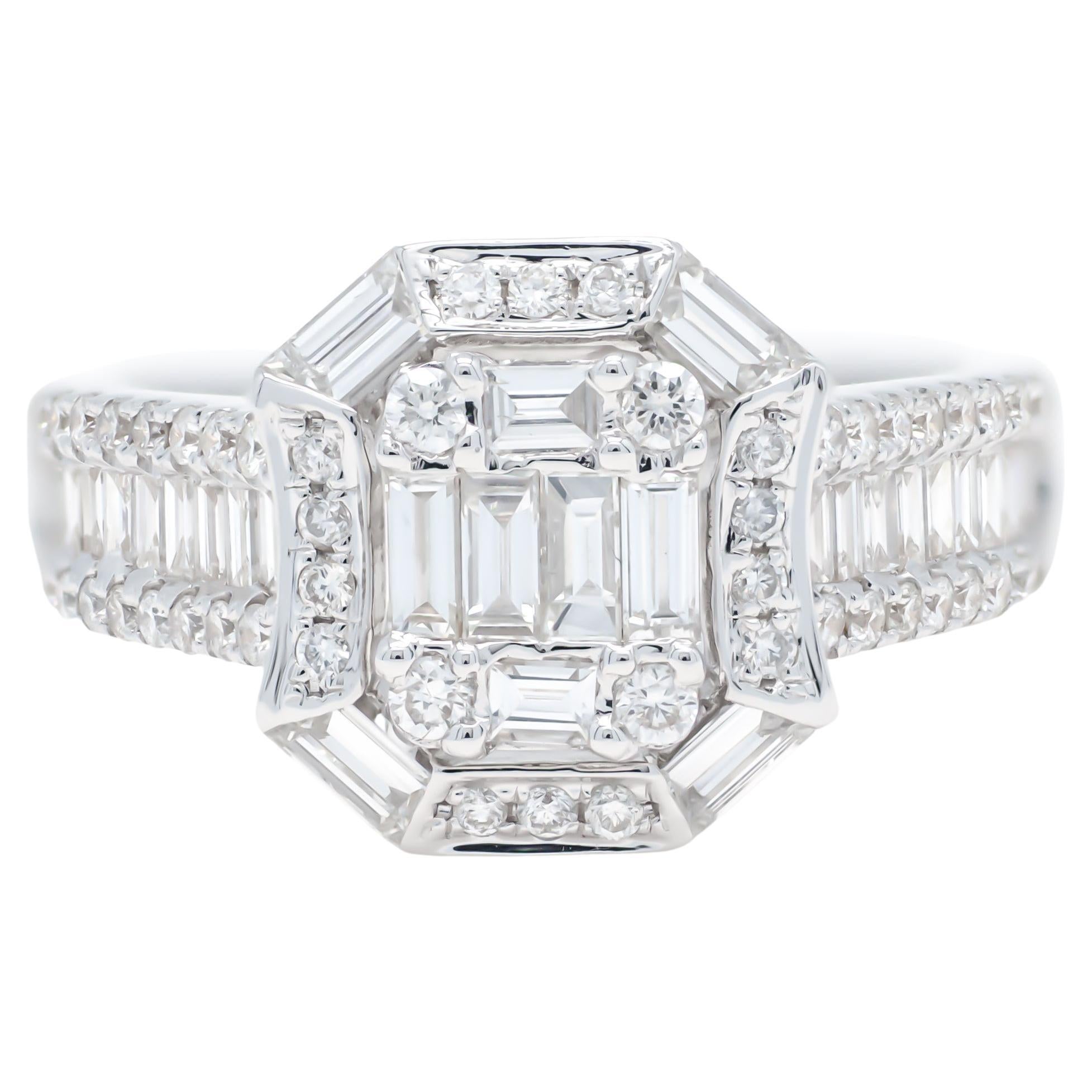 Say 'I do' to forever with this stunning 18KT White Gold Art Deco Baguette Round Diamond Cluster Halo Engagement Ring. The vintage-inspired design features a sparkling cluster of round diamonds encased in a halo of baguette diamonds set in an