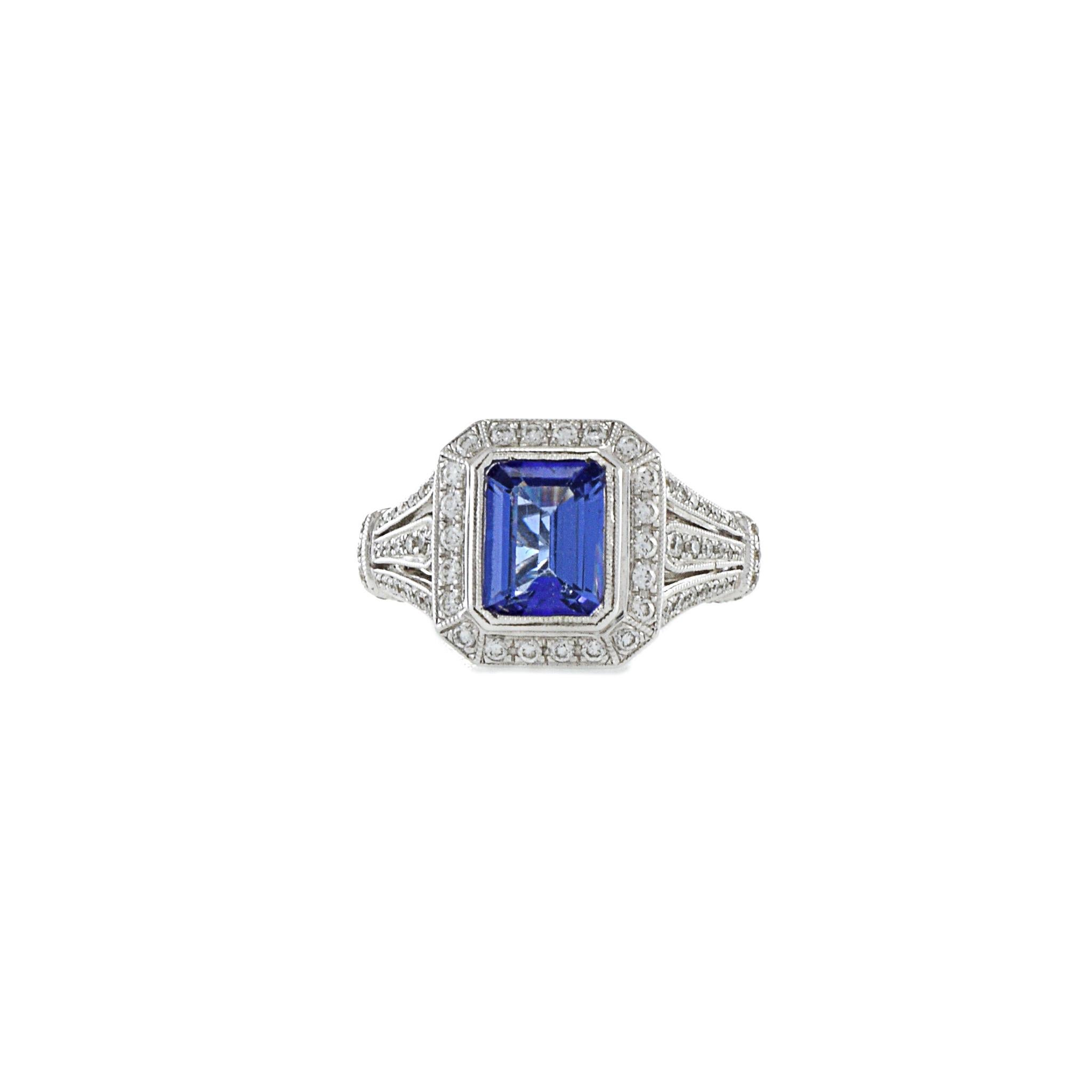 This bold art deco design ring, crafted in enduring 18KT white gold, embodies timeless elegance. The focal point is a striking 1.80CT emerald-cut tanzanite, accentuated by 0.48CT-TW of G color and VS1-VS2 clarity round-cut diamonds. The ring's